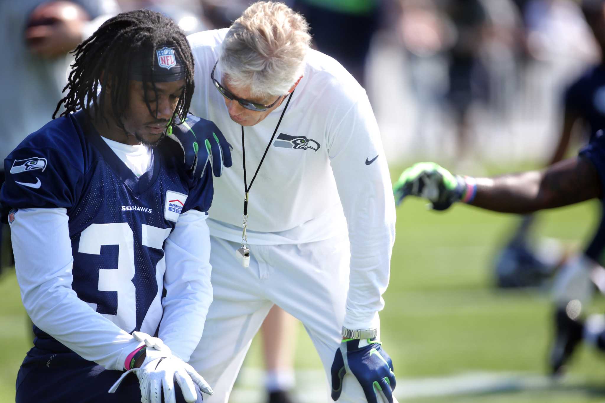 Seattle Seahawks wide receivers John Ursua (15) and Gary Jennings (11)  watch drills on the first