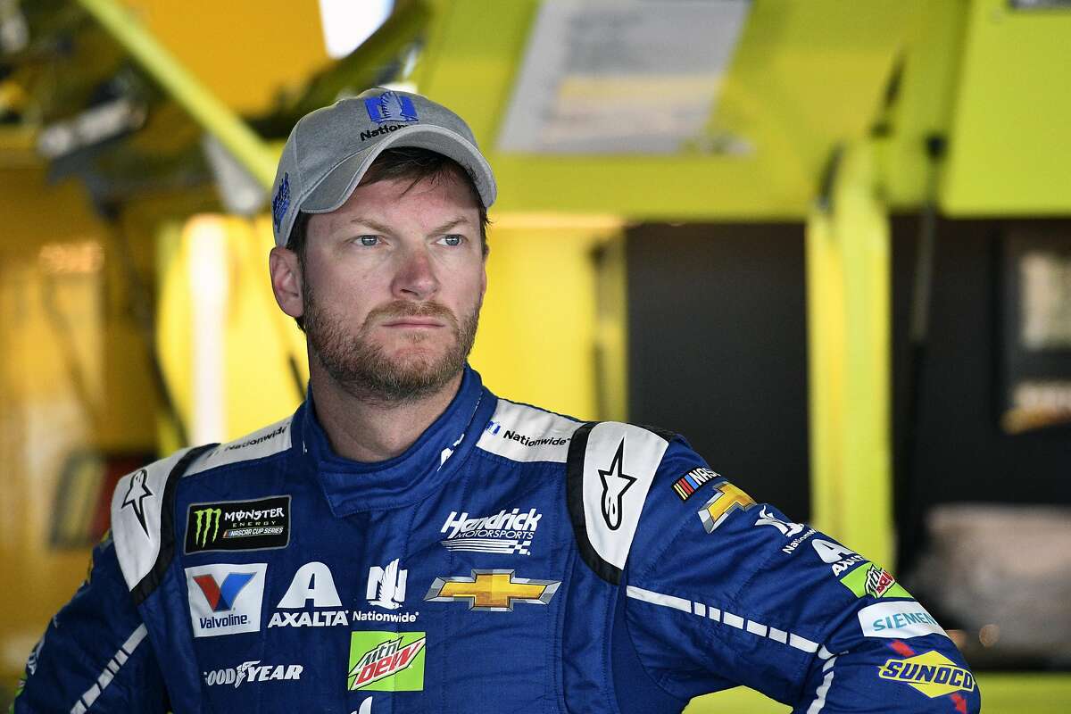 FILE - In this Saturday, June 3, 2017 file photo, Dale Earnhardt Jr. looks on in the garage during practice for the NASCAR Cup series auto race at Dover International Speedway in Dover, Del. NASCAR television analyst and former driver Dale Earnhardt Jr. was taken to a hospital after his plane crashed in east Tennessee. (AP Photo/Nick Wass, File)