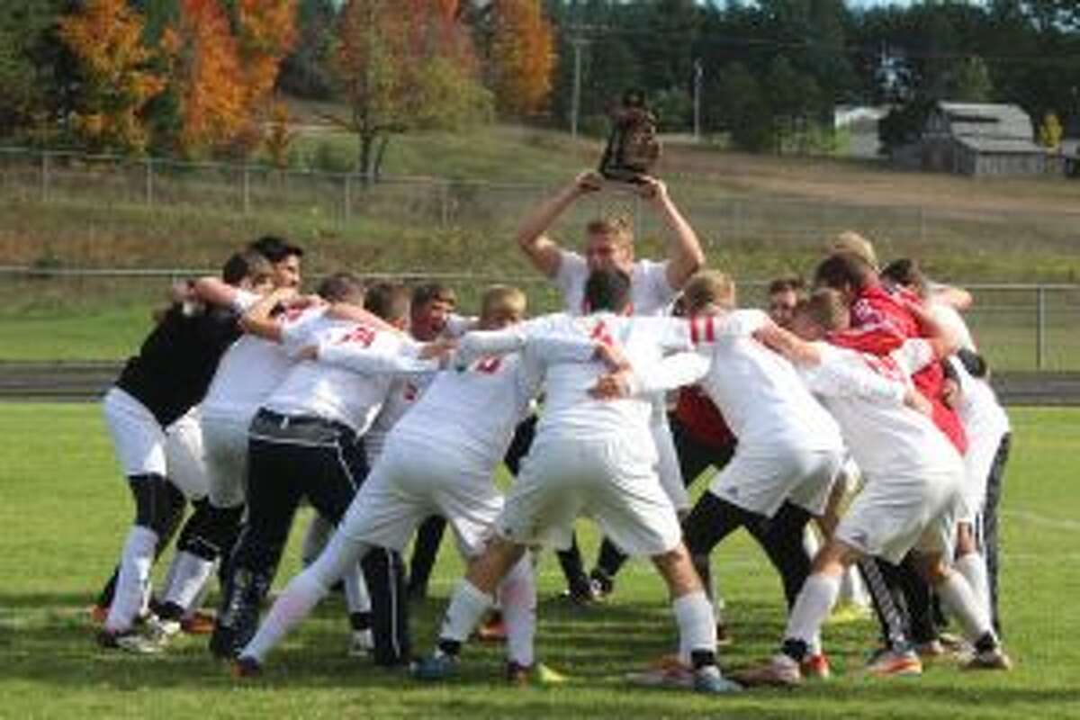 A FIRST TIME FOR EVERYTHING: The Benzie Central soccer team celebrates its first every district title on its way to an appearance in the regional final.