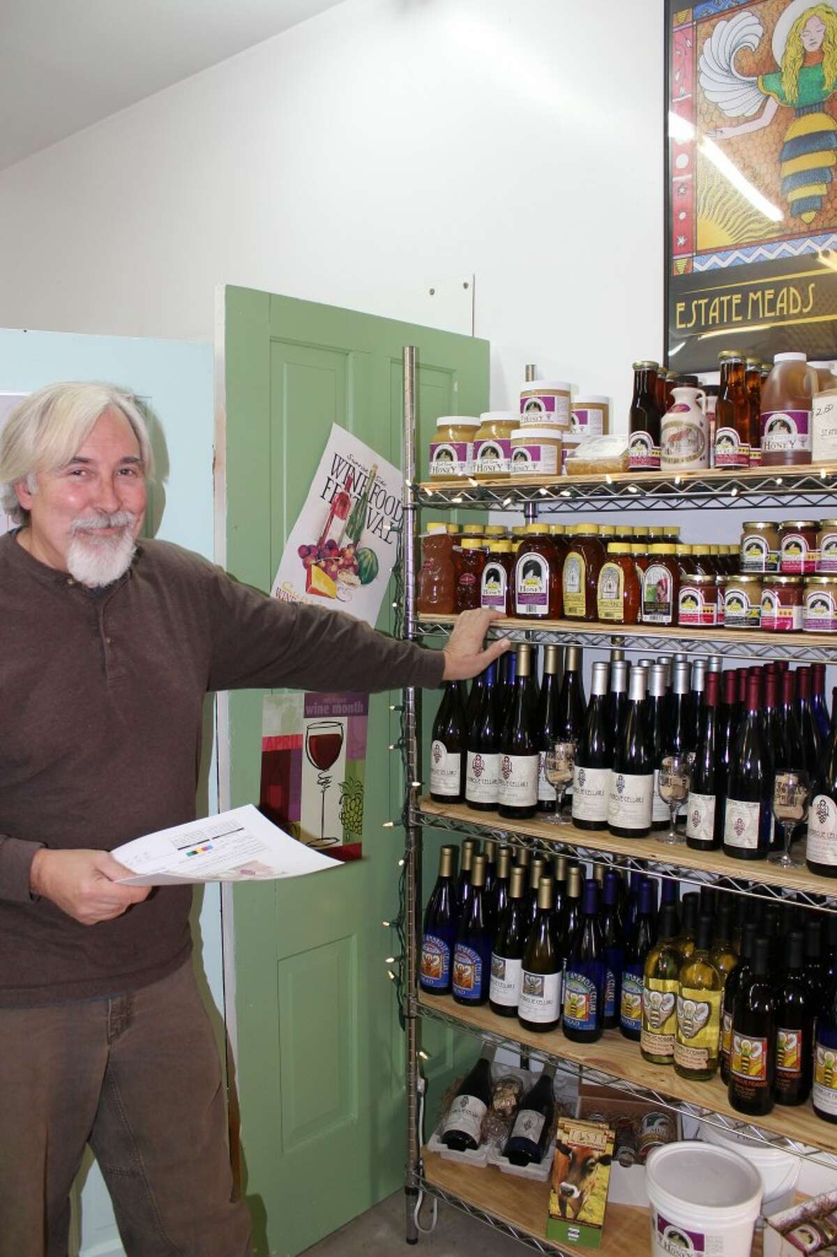 St Ambrose: Doug Coster, sales manager for St. Ambrose Cellars, said the market for mead, in Benzie and beyond, is doing quite well. So well, in fact, that they may soon begin distribution on the East Coast. St. Ambrose, which started marketing mead 2 years ago, makes traditional meads from honey and water, as well as meads with natural fruit flavors added. Acoustic Mead, a meadery in Lake Ann, creates meads of a different type; carbonated meads with a lower alcoholic content that are more “quaffable”, according to Acoustic owner Bruce Grossman. (Photo by Colin Merry)