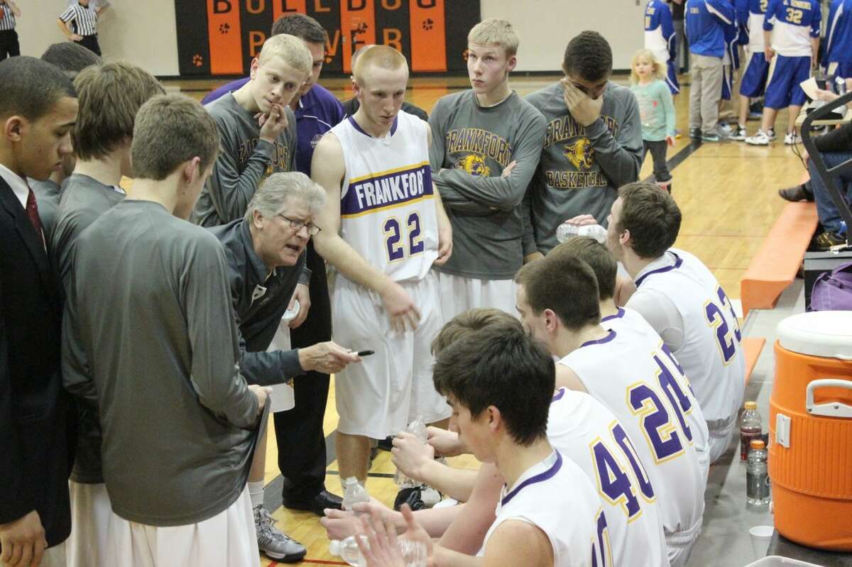 Coach in the Huddle: Head Coach Reggie Manville talks to his players during a time-out in the championship game against the Onekama Portagers on March 8.
