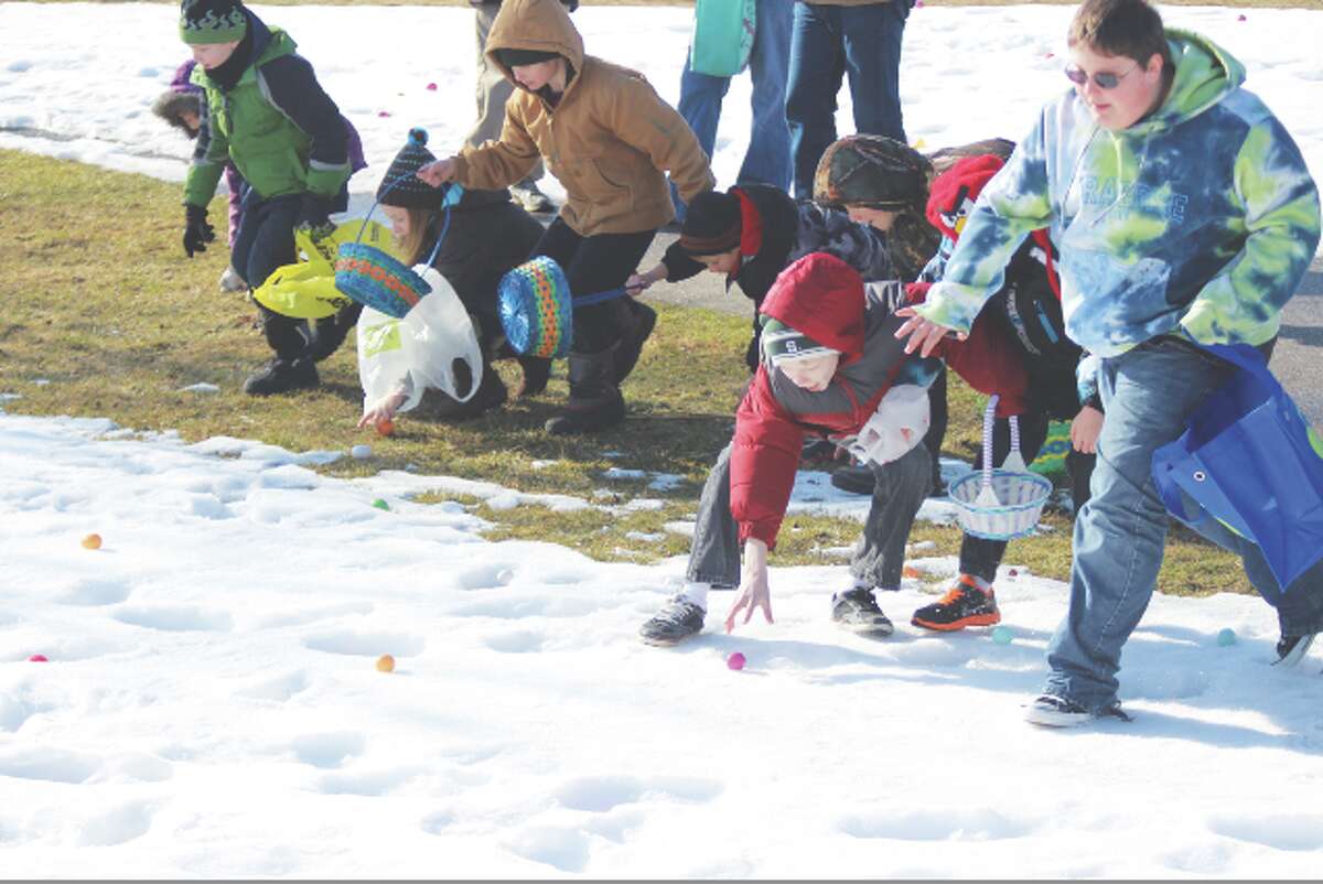 They’re Off: Children begin gathering eggs as they charge into Mineral Springs park to collect goodies left by the Easter Bunny.