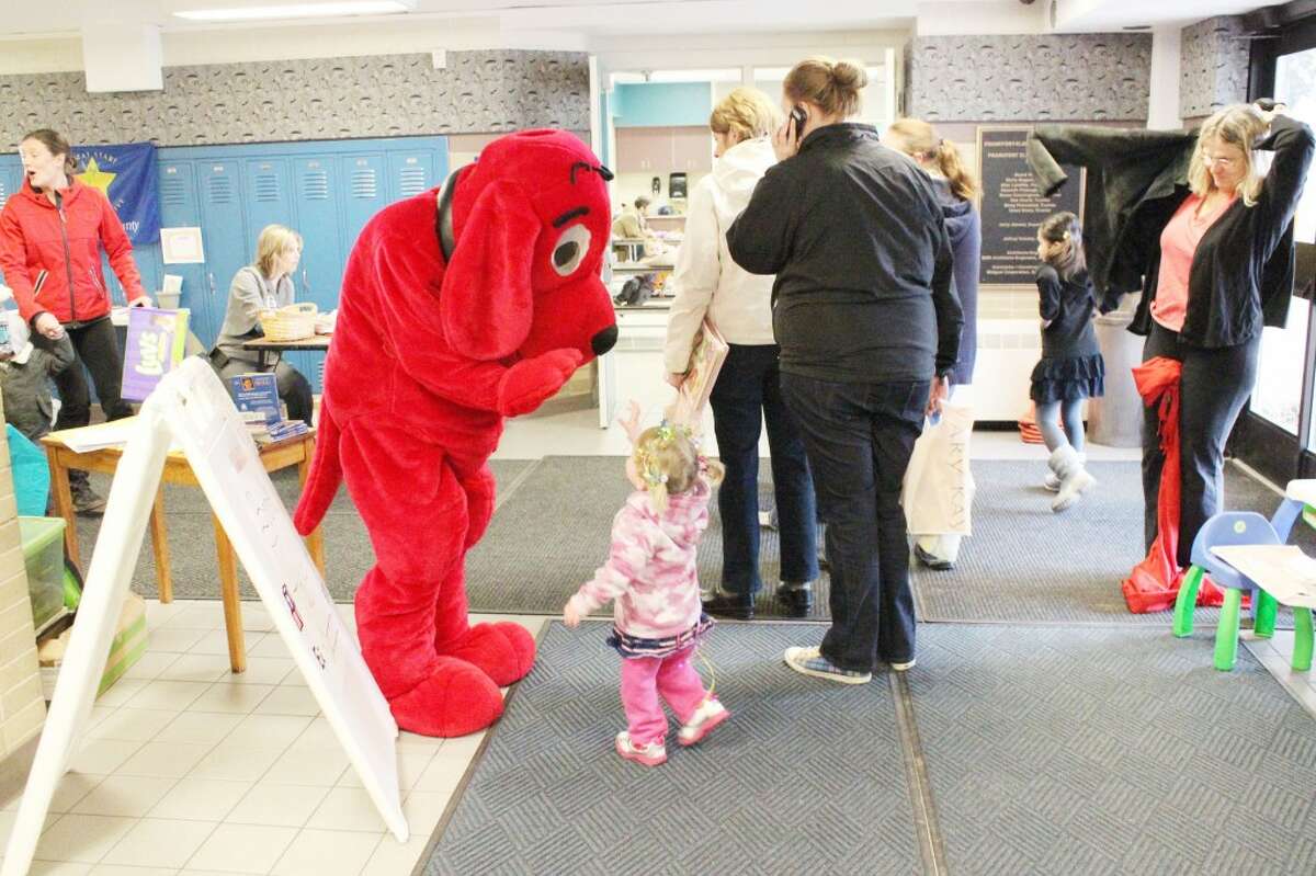 HELLO: A little girl waves hello to Clifford the Big Red Dog, who visited the Early Childhood Open House on Saturday and will return again today. The event is held at Frankfort Elementary School. (Photo/Bryan Warrick)