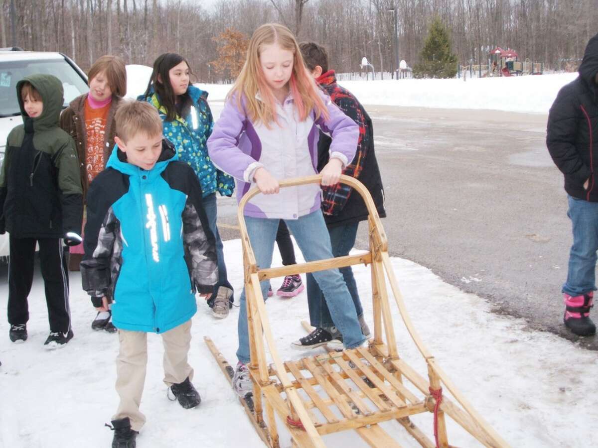 TYING IT IN: Students from Lake Ann Elementary took turns on a real-life dog sled when local racer AJ Schibelhut visited, which was connected to a book the class was reading. (Courtesy photo/Tammy Wing)