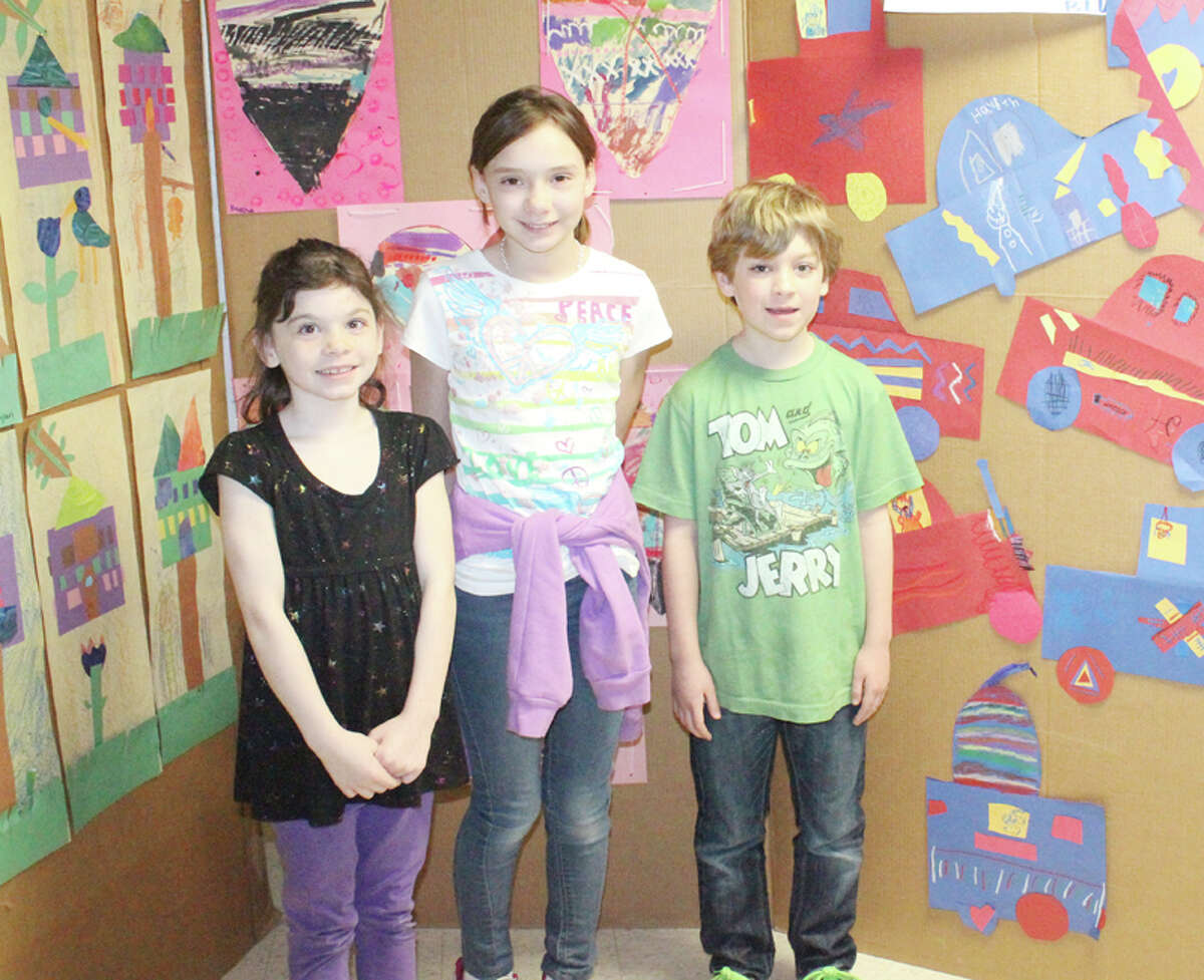 FUNDRAISER: Crystal Lake Elementary students, (from left to right) Patience Wenkel, Emma Quick and Lennon Maue stand by their art on display at the Crystal Lake Art Show fundraiser on April 16. The fundraiser brought in more than $2,000 to use for field tripsand school supplies. (Photo/Bryan Warrick)
