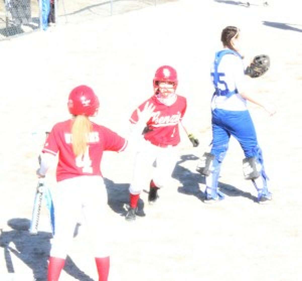Benzie Softball scores- “The Huskies score a run during the opening game with St. Mary’s. The Benzie Central Huskies offense was big in the first game, putting up six runs.” (Photo/Bryan Warrick)