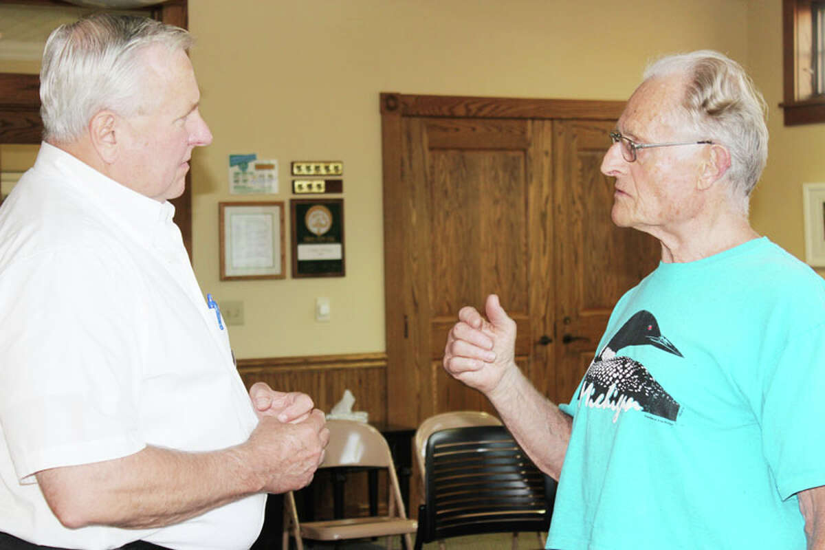 A GROWING PROBLEM: Rep. Ray Franz talks with Jerry Brace about the increasing number of scams that target senior citizens, many of which are devising new ways to fool people into parting with their money. (Photo/Colin Merry)