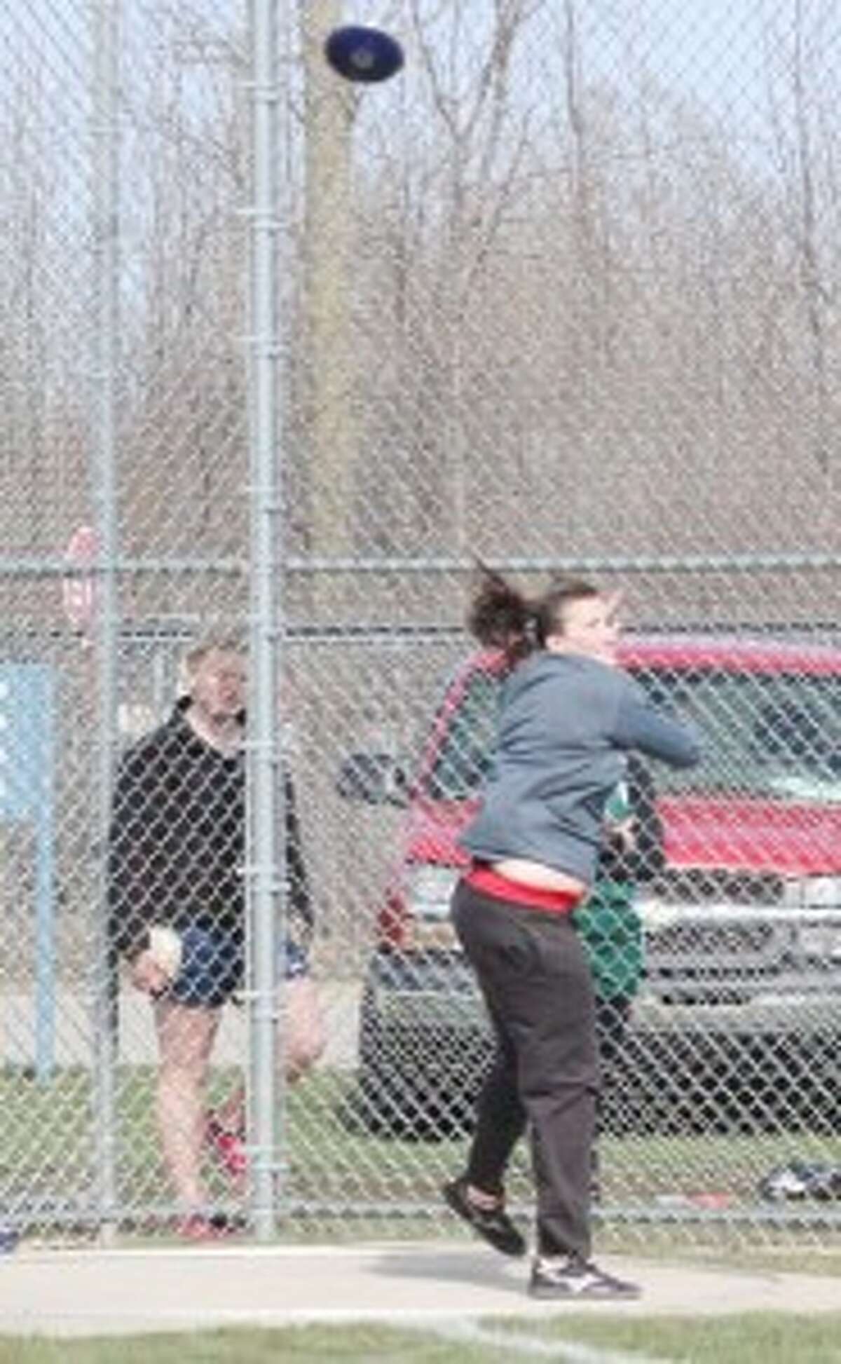 DISCUS: Senior Madison Lutzke throws a discus during Benzie Central High School track team’s busy week (Photo/Bryan Warrick)
