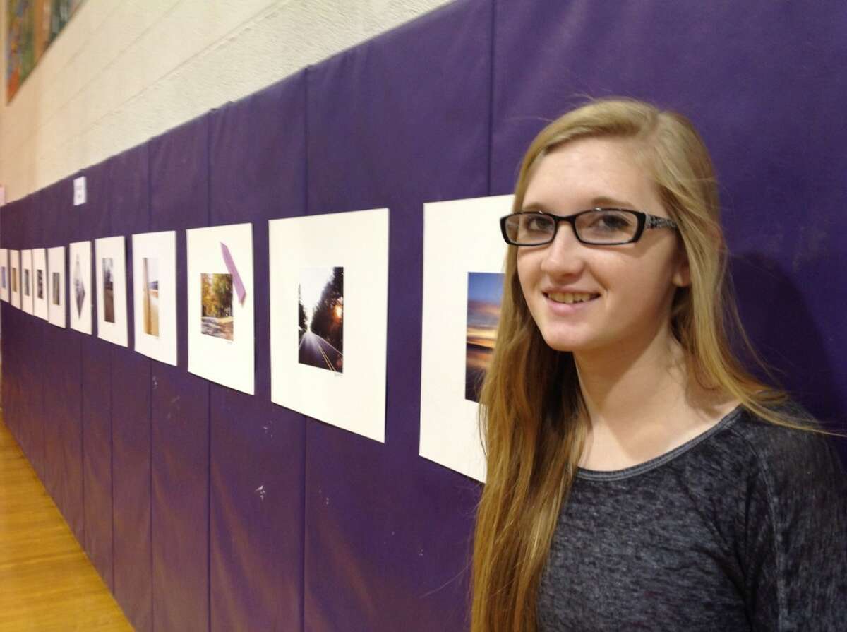 ARTIST BY HER WORK: Frankfort high school student Kaitlyn Ward shows off her photographs she entered in the event held at the school on May 16.