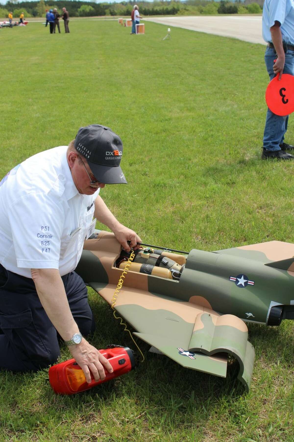 PRE-FLIGHT: Marshal Emmendorfer prepares his F-4 Phantom for takeoff at the Benzie Area Radio Control Club Spring Thing held Saturday in Thompsonville. The jet-powered plane can reach speeds of up to 200 miles per hour.