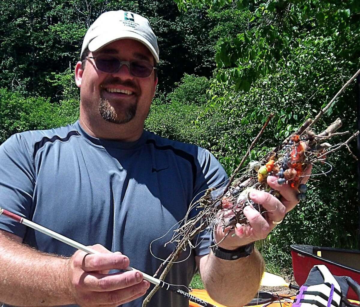 TANGLED: Mike Jones, conservation specialist for the Benzie Conservation District, holds a tangle of fishing line and lures pulled out of the Betsie River at a previous Clean Sweep.