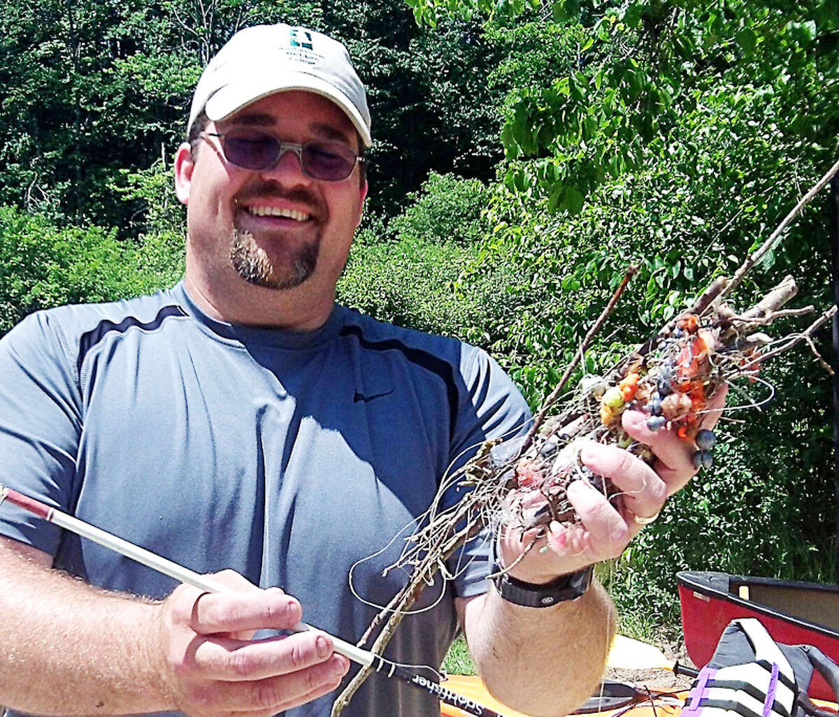 TANGLED: Mike Jones, conservation specialist for the Benzie Conservation District, holds a tangle of fishing line and lures pulled out of the Betsie River at a previous Clean Sweep.
