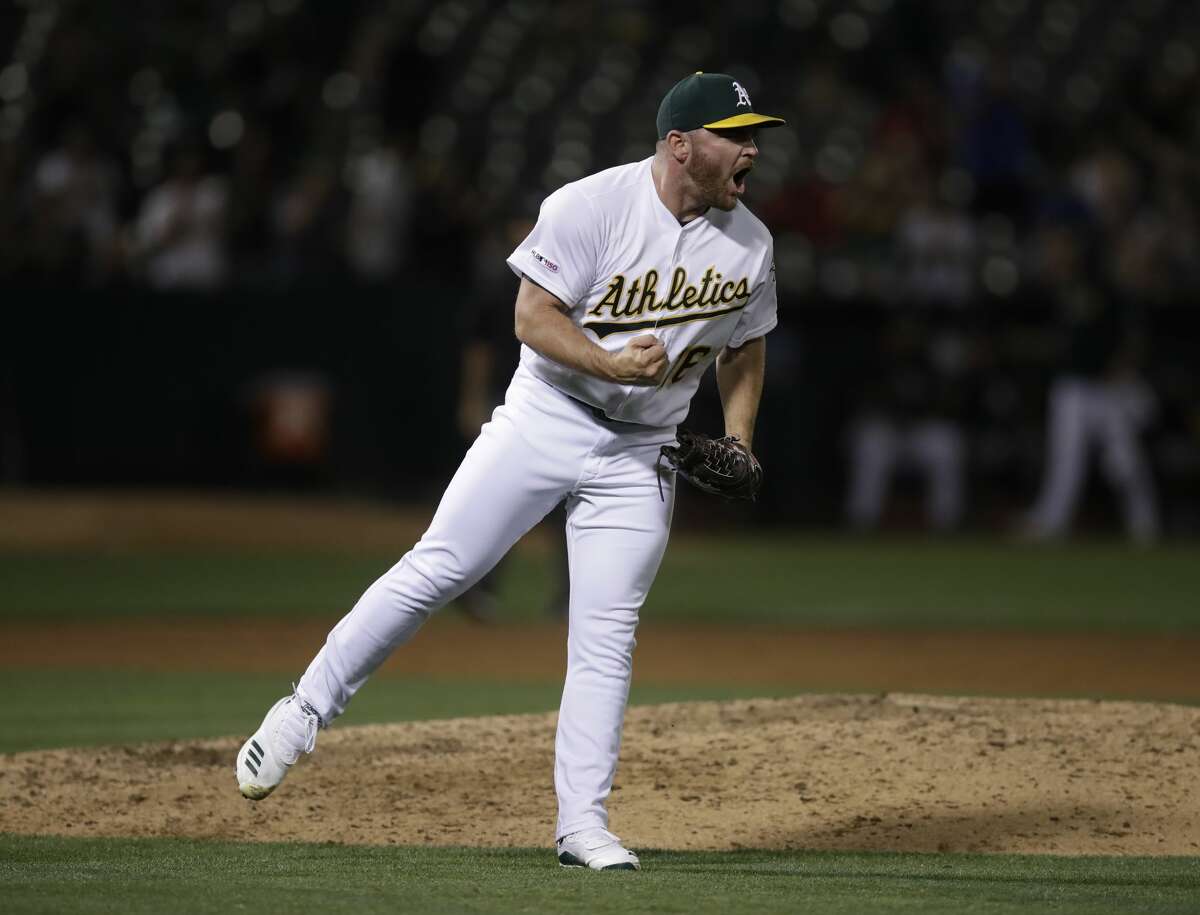 Oakland Athletics' Liam Hendriks reacts as the final out is made against the Houston Astros in a baseball game Thursday, Aug. 15, 2019, in Oakland, Calif. (AP Photo/Ben Margot)