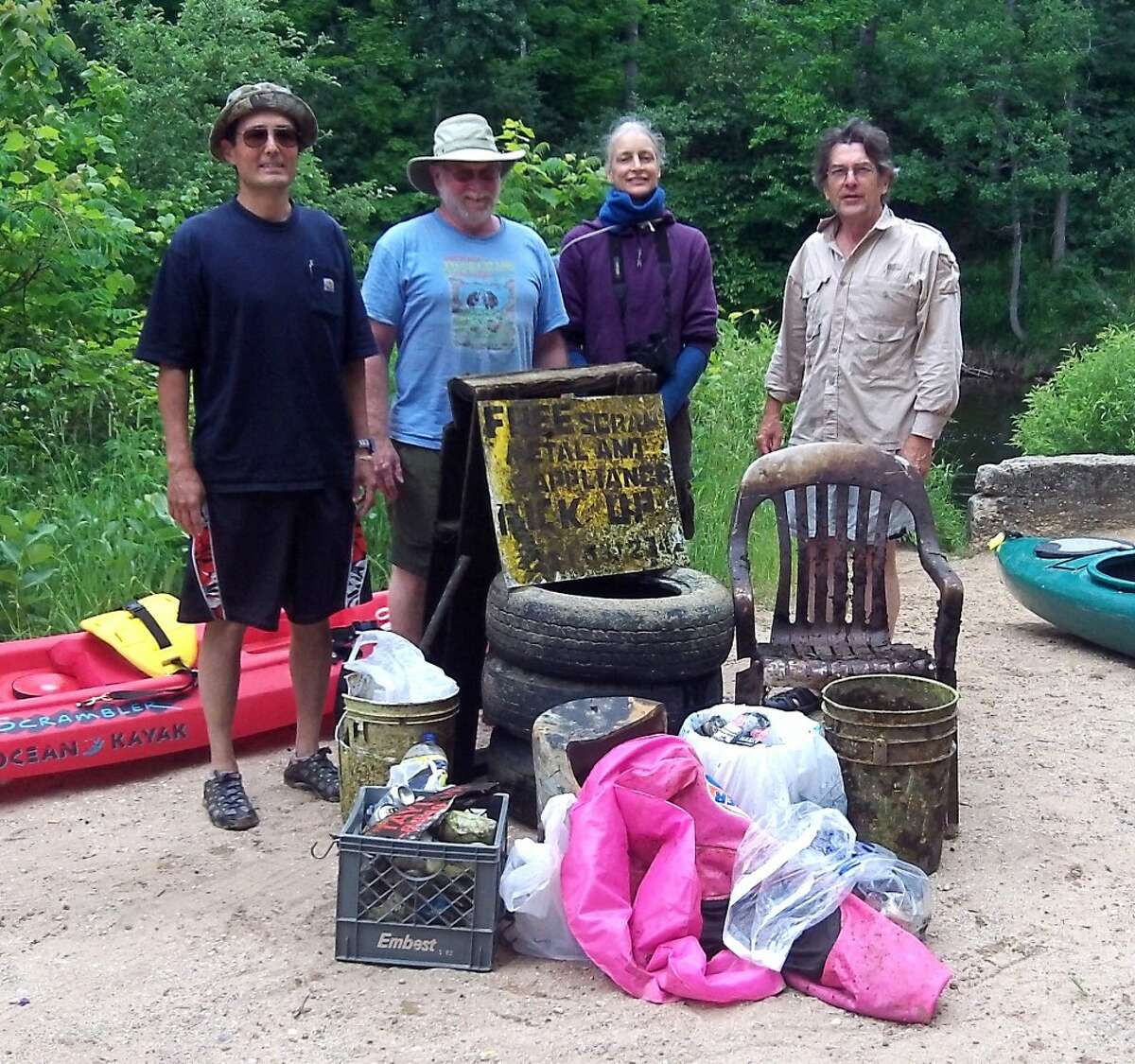 KEEP IT CLEAN: Volunteers for the Benzie Conservation Districts clean sweep pose with some of the trash they hauled out of sections of the Betsie River. In total, 300 to 400 pounds of trash were removed from the river. (Courtesy photo)