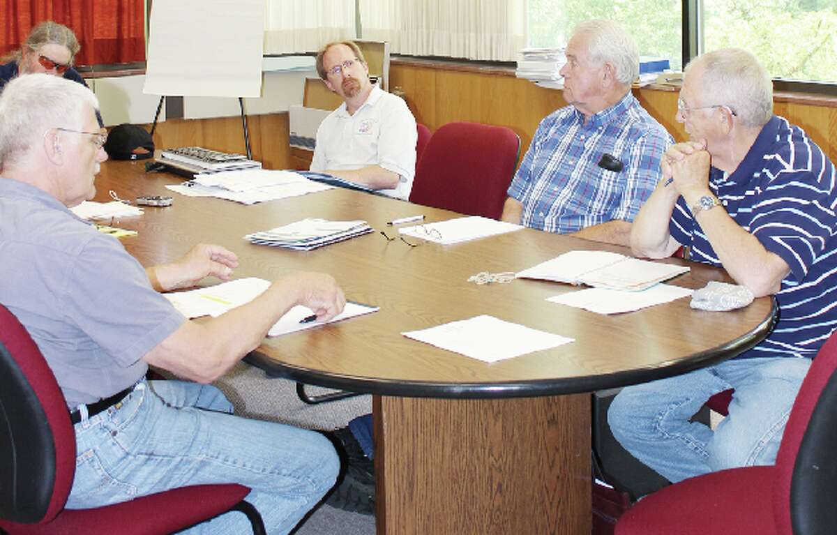 LOOKING AT OPTIONS: Commissioners Glen Rineer, Don Tanner, Tom Kelly and Roger Griner go over the options Benzie County can take while looking for a new county administrator with current administrator, Chris Olson at the July 9 Human Resources Committee meeting (Photos/Colin Merry)