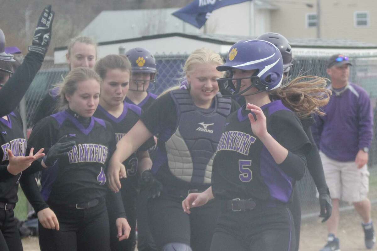 Haley Myers is congratulated by her teammates after a home run.