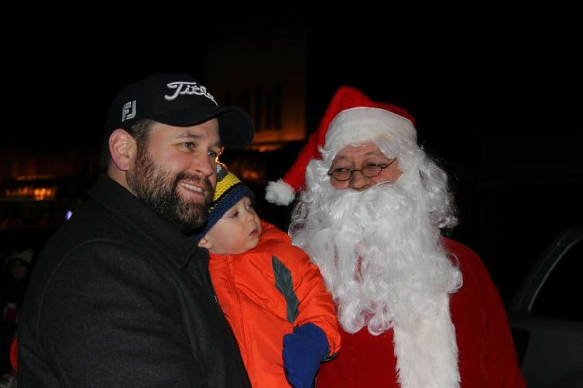SPECIAL VISIT: Santa Claus visits with Declan Herron, and his father, Sean, during the Frankfort Tree Lighting event, on Saturday. (Photos/Colin Merry)