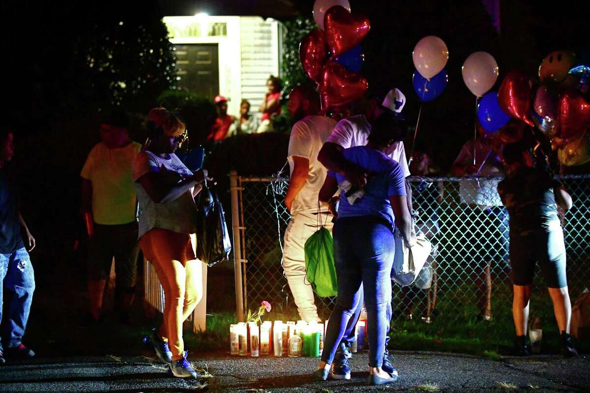Family members and friends gather to hold a vigil for the stabbing victim at 39 Faifield Ave. on Aug. 8 in Norwalk.
