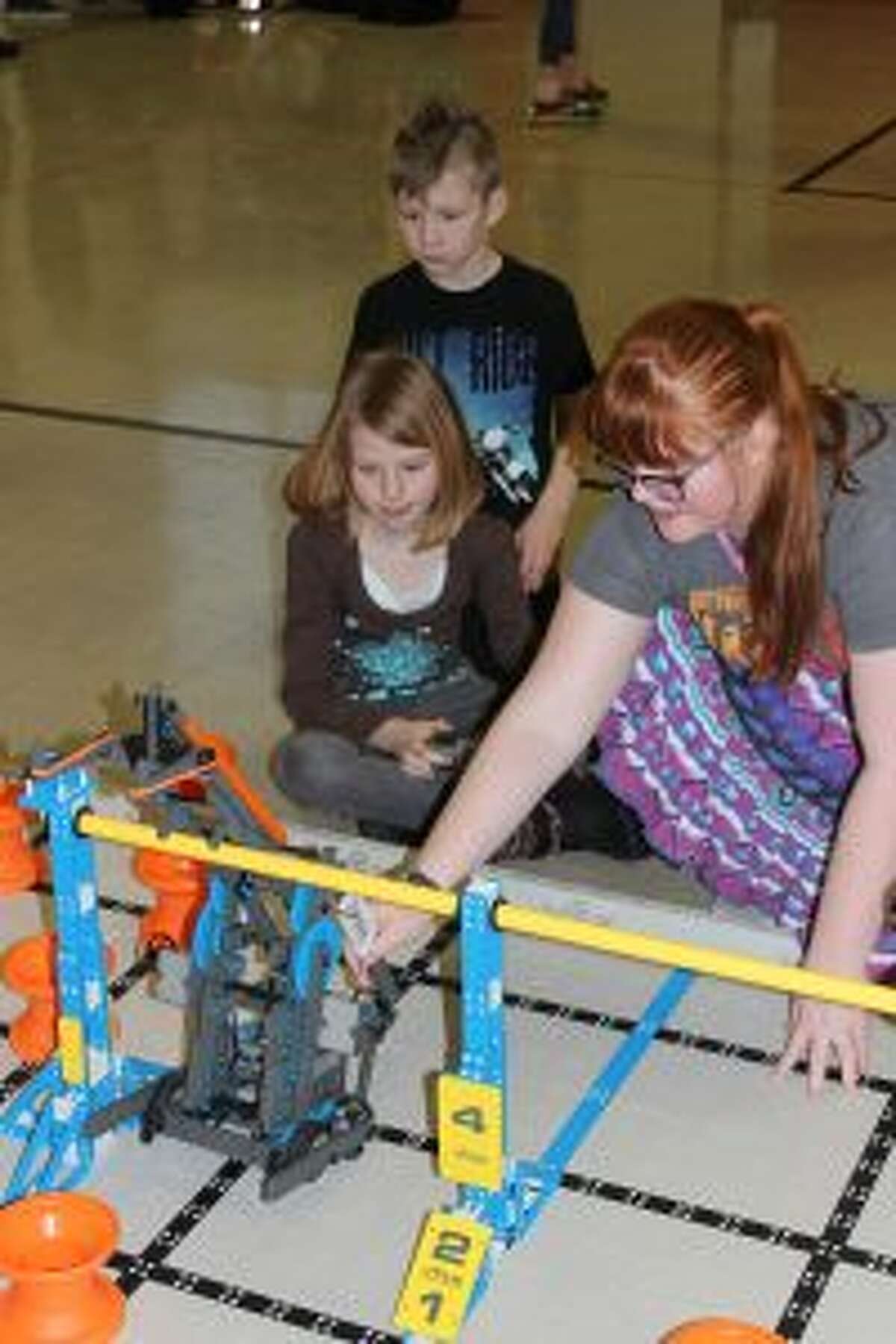 Benzie Central seventh grader Victoria Lung shows Betsie Valley Elementary students how to drive one of the robots that the middle school robotics club uses for competitions. (Photos/Robert Myers)