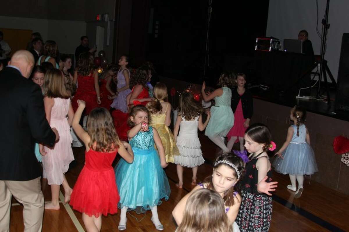 DANCE TIME: Girls at the Daddy Daughter Dance get down with each other and their dads while the DJ plays popular music and music videos.