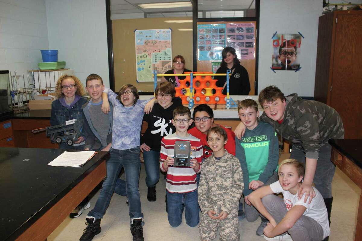 The Benzie Central Middle School robotics team (pictured front row, left to right) Jessica Decker, Dade Allen, Emily Fouchey, Ella Gaylord, Anderson Graetz, Jonathan Rollo, Oliver Meno, Emmett Jaquish, Dylan Carpenter, Rojan Meno; (back row left to right) Victoria Lung and Anastasia Davis meets to work on their robots following their most recent competition. (Photo/Robert Myers)
