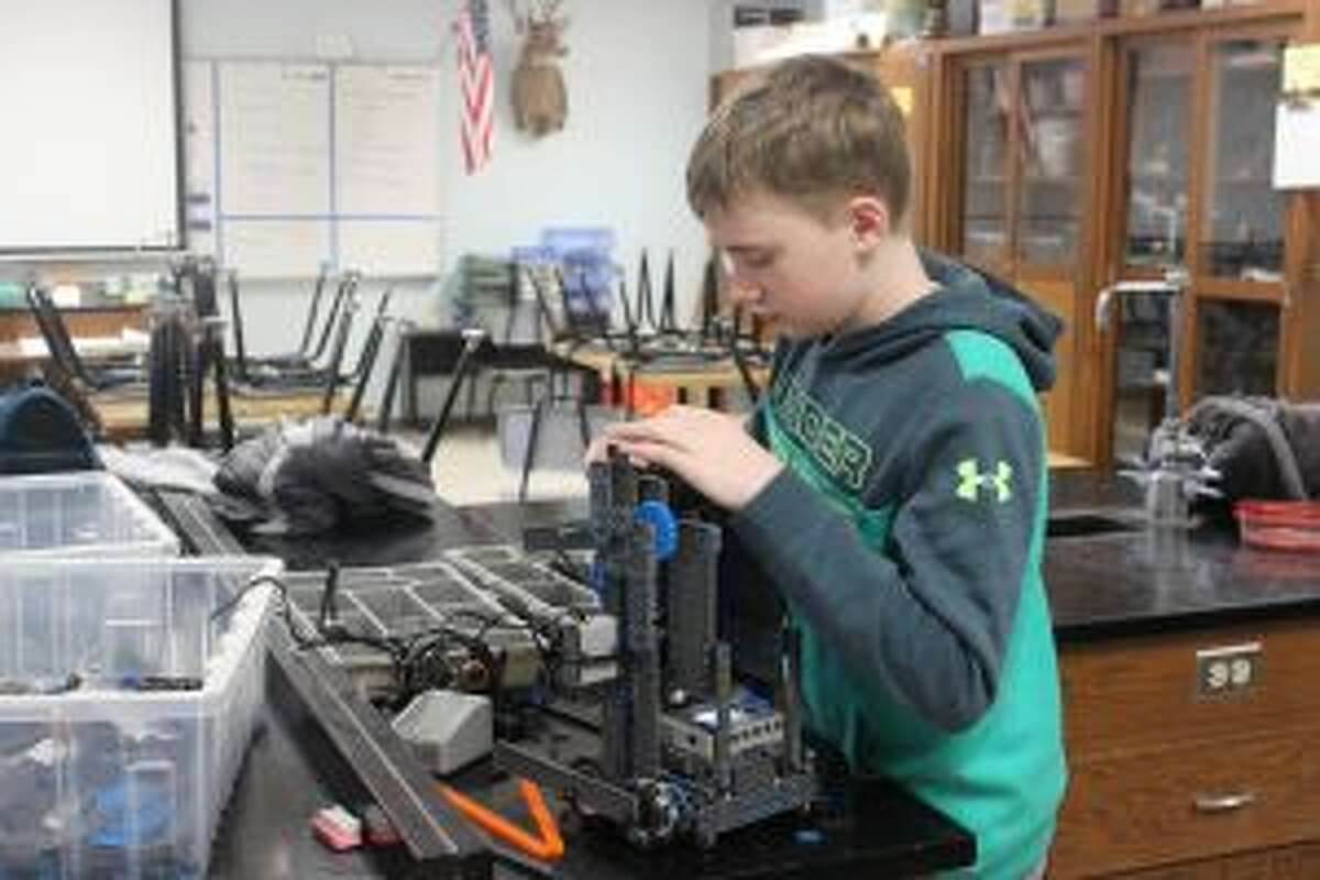 Emmett Jaquish works on the sixth and seventh grade team’s robot. (Photo/Robert Myers)