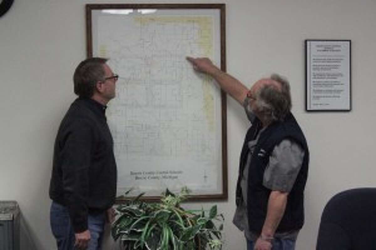 BUS POLICY: Benzie Central Superintendent Dave Micinski (left) and Director of Transportation Guy Sauer look over the bus route map, showing some of the roads effected by the new Main Road Policy. (photo/Bryan Warrick)