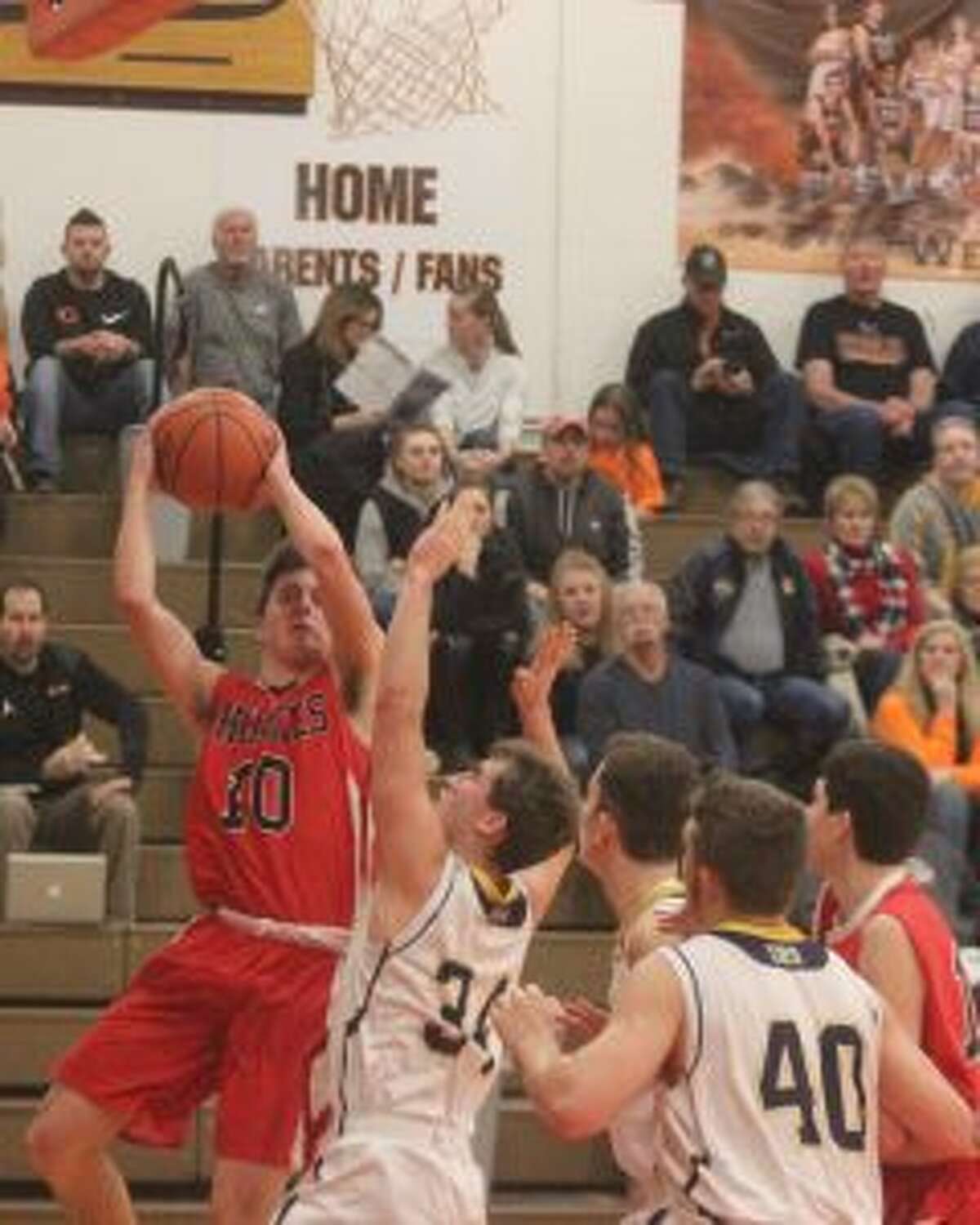 Benzie Central senior Ryan Kennedy tries to battle through contact for a layup. (Photo/Robert Myers)