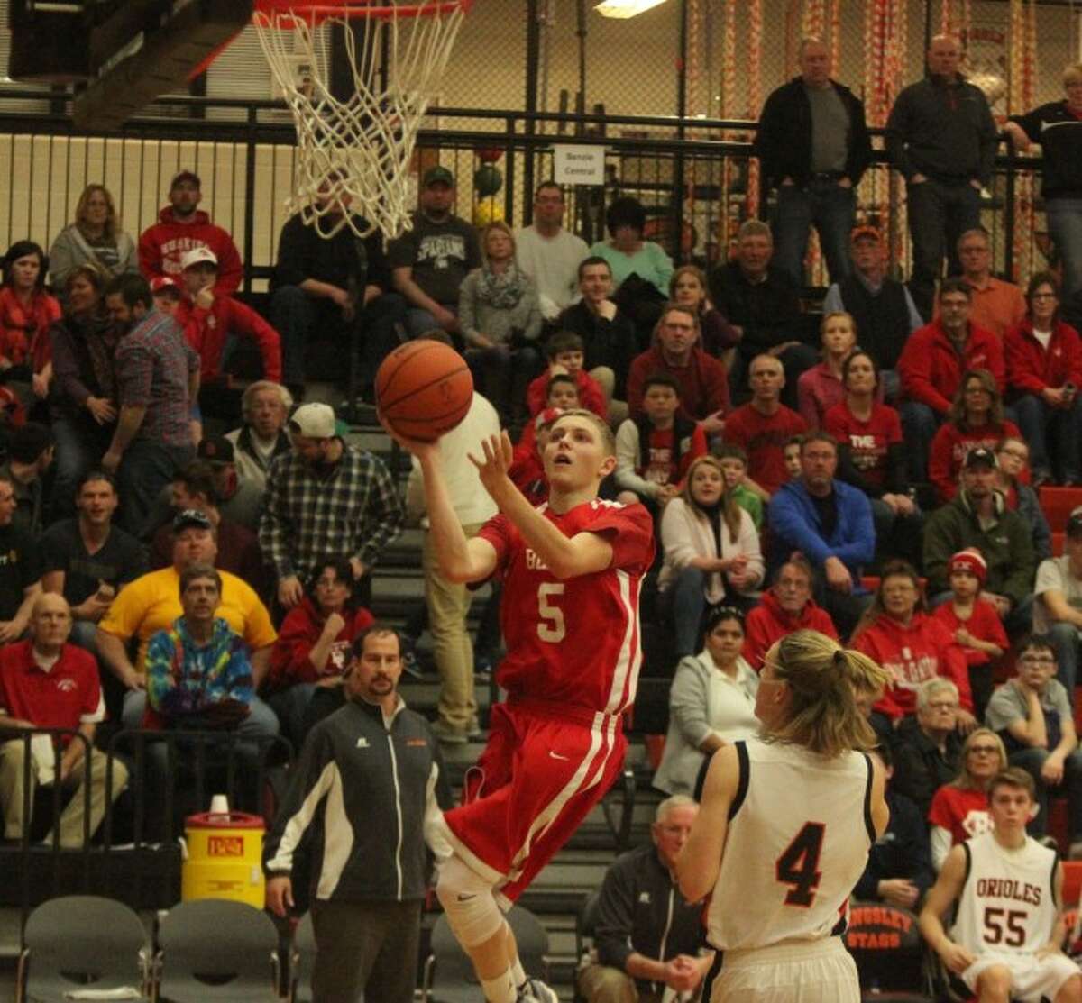 KNOWING HOW TO SCORE: Kyle Smith proved he could score at Benzie Central, whether it meant taking advantage of his deep jumper or navigating traffic to the basket as he does here in the district final against Ludington.