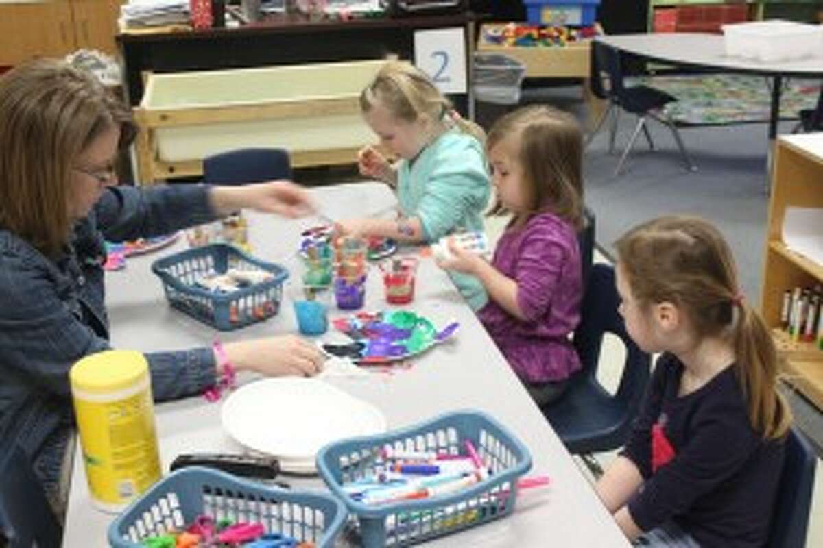 PAINTING THE FISH: Students in the Crystal Lake Co-op Preschool work hard on their crafts during class. The program gives the students a chance to have fun while also learning. It helps in the transition into kindergarten the following year.
