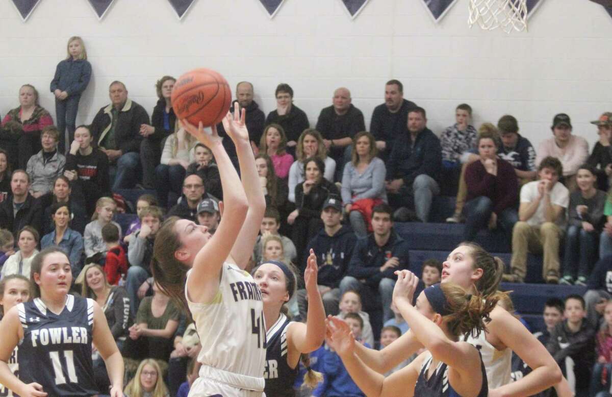 Emily Loney tries to go back up with the ball after grabbing an offensive rebound. (Photo/Robert Myers)