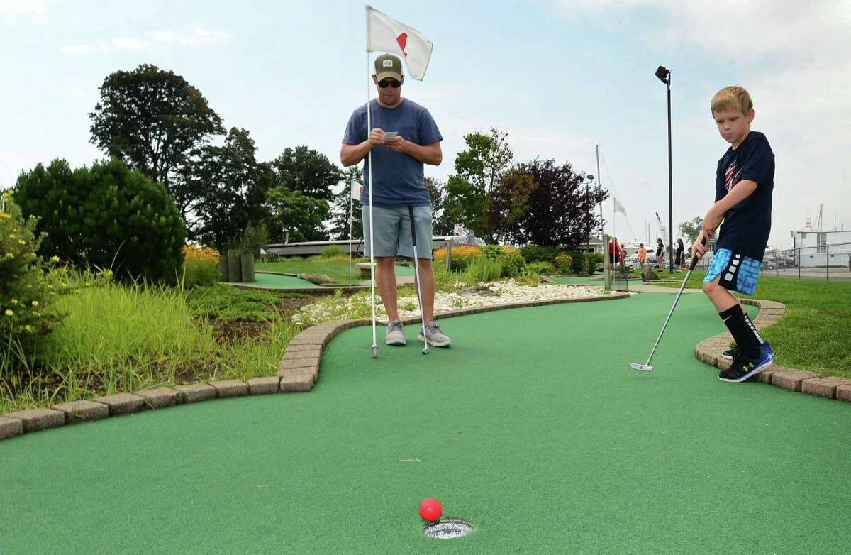 Westport resident Jeff Zuckerman plays Miniature Golf with his family including his son Will Zuckerman, 8, at Cove Marina Wednesday, August 14, 2019, in Norwalk, Conn.