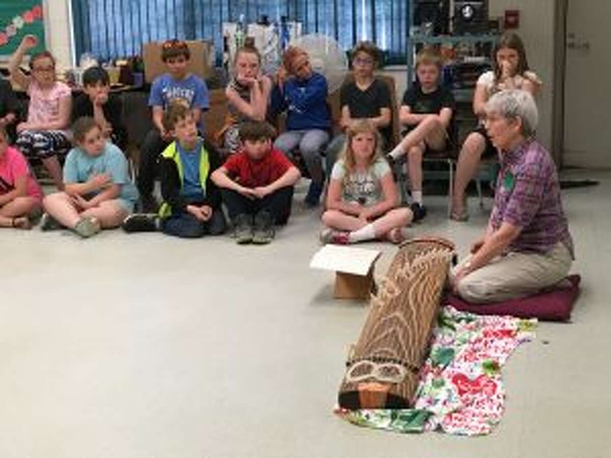 Local musician Ginny Freeman demonstrates her Japanese Koto to students in Nancy Reed’s music class at Lake Ann Elementary.