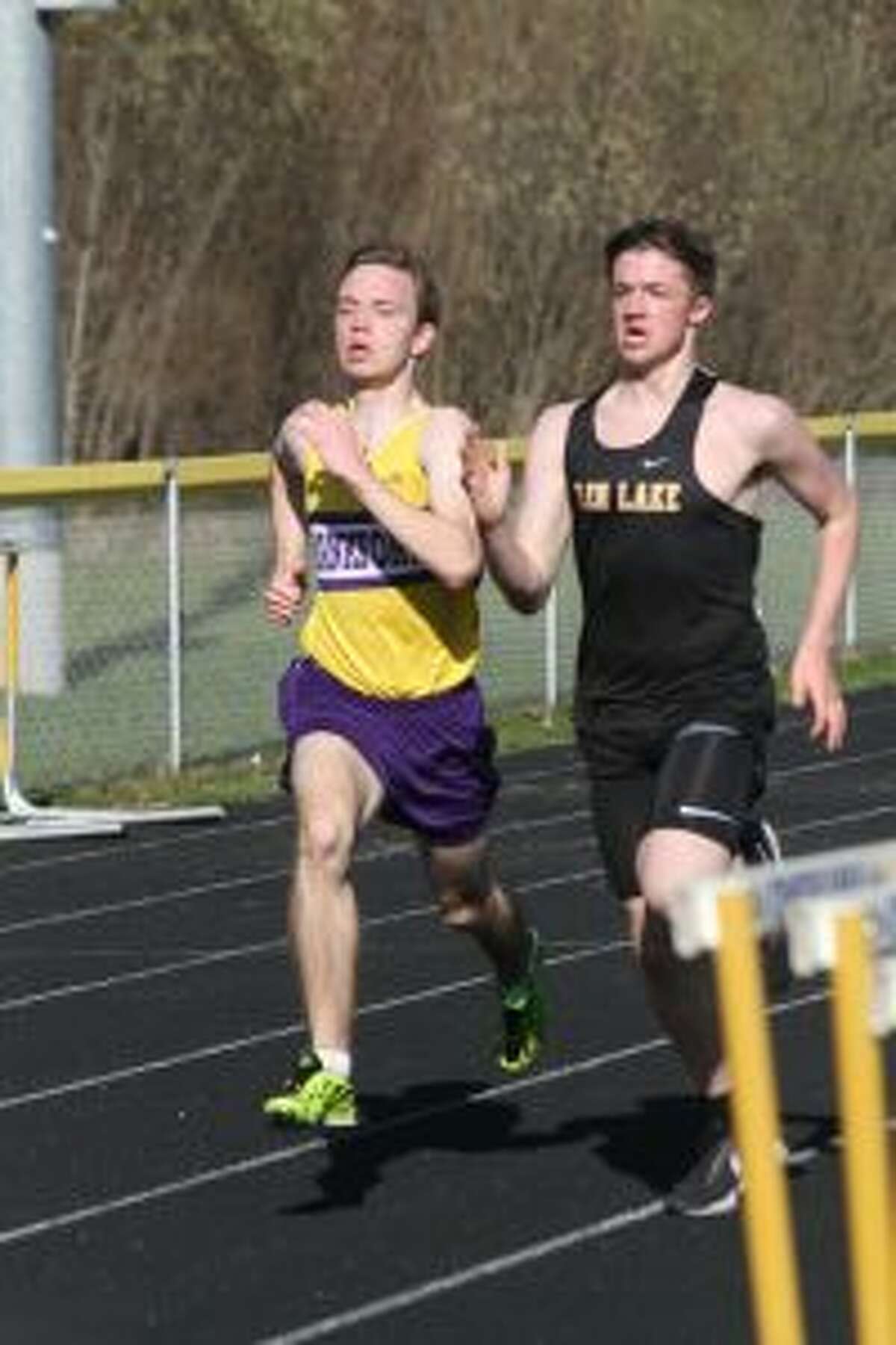 Owen Roth pushes past Glen Lake's Tommy Reay near the finish line to win the 1,600-meter run. (Photo/Dylan Savela)