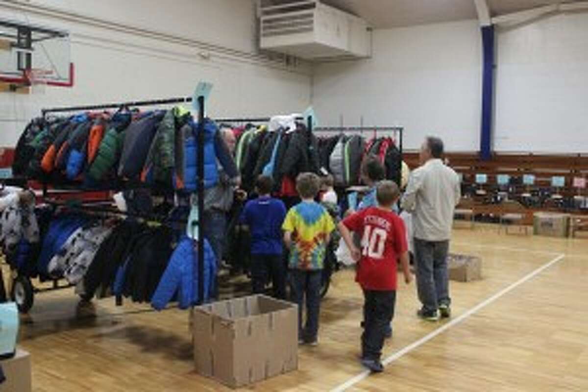 BIG SELECTION: Boys look over the large selection of cool winter coats to try on at Platte River Elementary School. Students from around the district stopped by to get prepared for the winter weather.