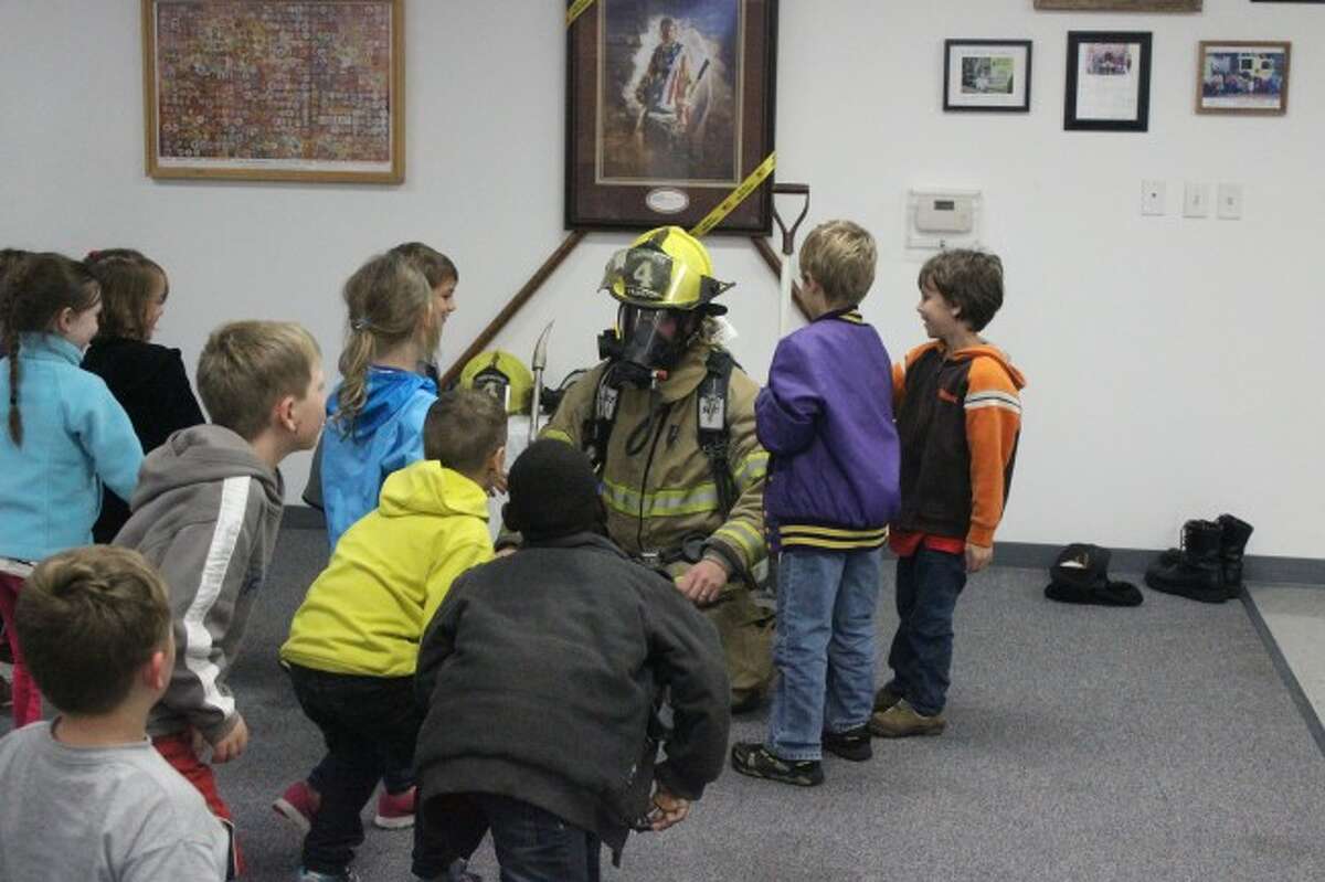 UP CLOSE: An important lesson the students learned during their visit to the Fire Station was to not be afraid of firefighters during an emergency. To help with the lesson, students got to see a firefighter in full equipment up close. (Photos/Bryan Warrick)