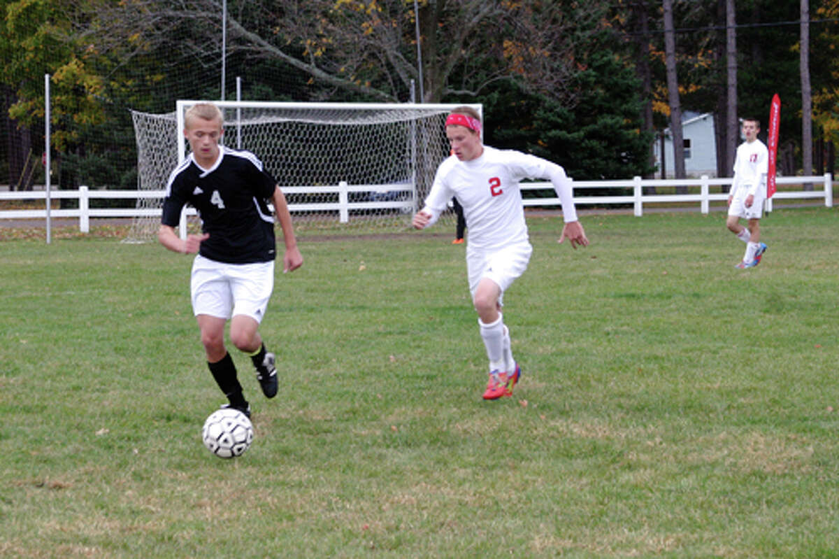 RUNNING IT DOWN: Senior Zach Perry (2) runs down the ball to take it from an opposing player.