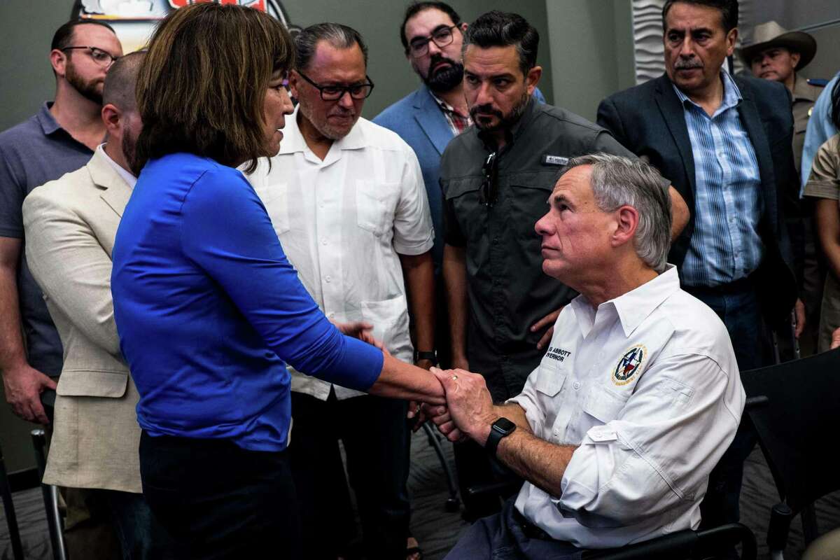 Texas Representative Evelina "Lina" Ortega (L) shakes the hands of Texas Governor Greg Abbott after a press briefing, following a mass fatal shooting, at the El Paso Regional Communications Center in El Paso, Texas, on August 3, 2019. - A gunman armed with an assault rifle killed 20 people Saturday when he opened fire on shoppers at a packed Walmart store in the latest mass shooting in the United States. (Photo by Joel Angel JUAREZ / AFP)JOEL ANGEL JUAREZ/AFP/Getty Images