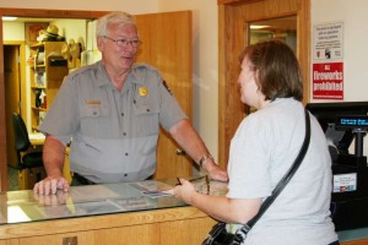 PARK SERVICE: Robert Johnson, a visitor’s use assistant with the park, saw an increase in visitors at the Sleeping Bear Dunes National Lakeshore Visitor’s Center. Johnson said many of the visitors had learned about the park thanks to being voted the “Most Beautiful Place in America” on Good Morning America. (Photo/Roland Halliday)