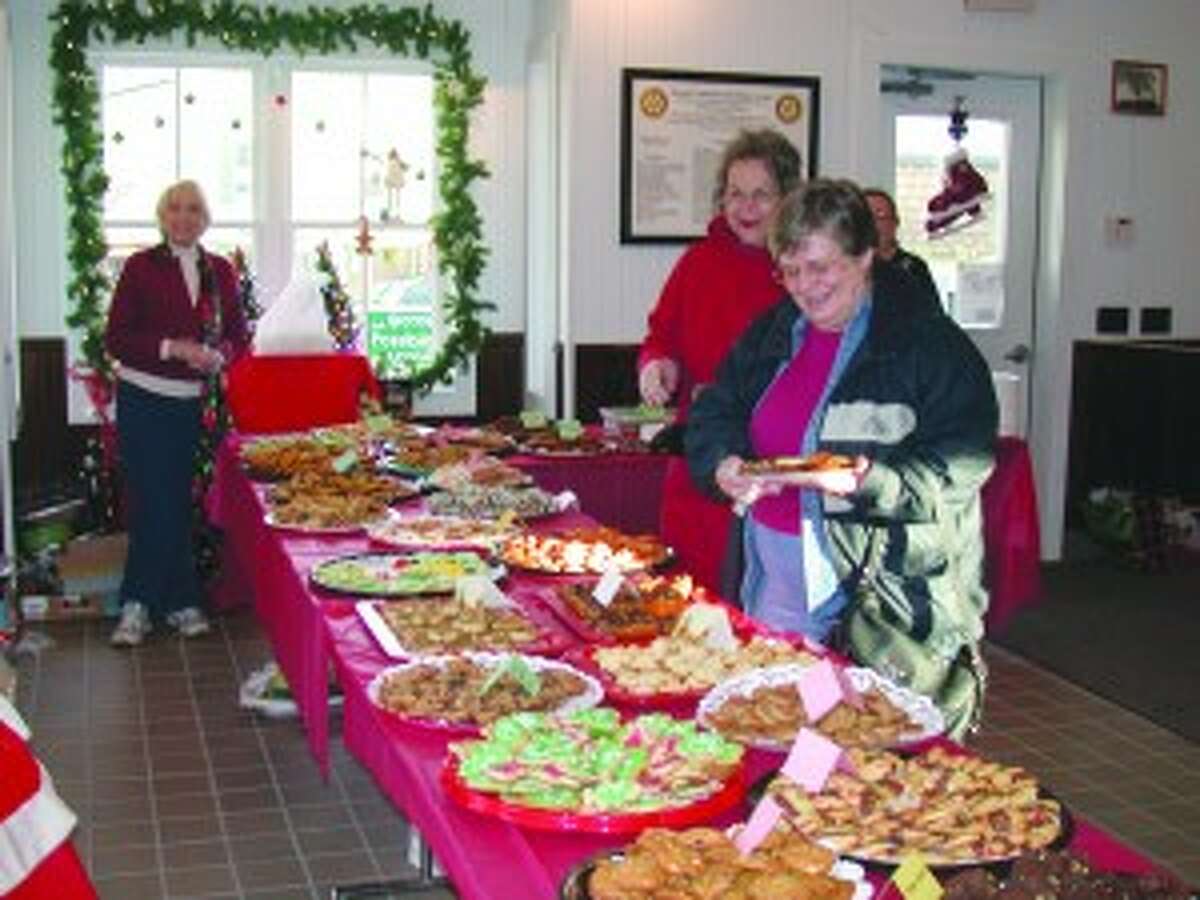 BOOK SALE: Patrons of last year’s Christmas Cookie and Book Sale check out the selection of home-made cookies, along with other treats, at annual The Friends of the Darcy Library and Book Sale. Many variety of cookies are always available, and many shoppers stock up for holiday company, eliminating the need to bake cookies themselves. (Courtesy photo)