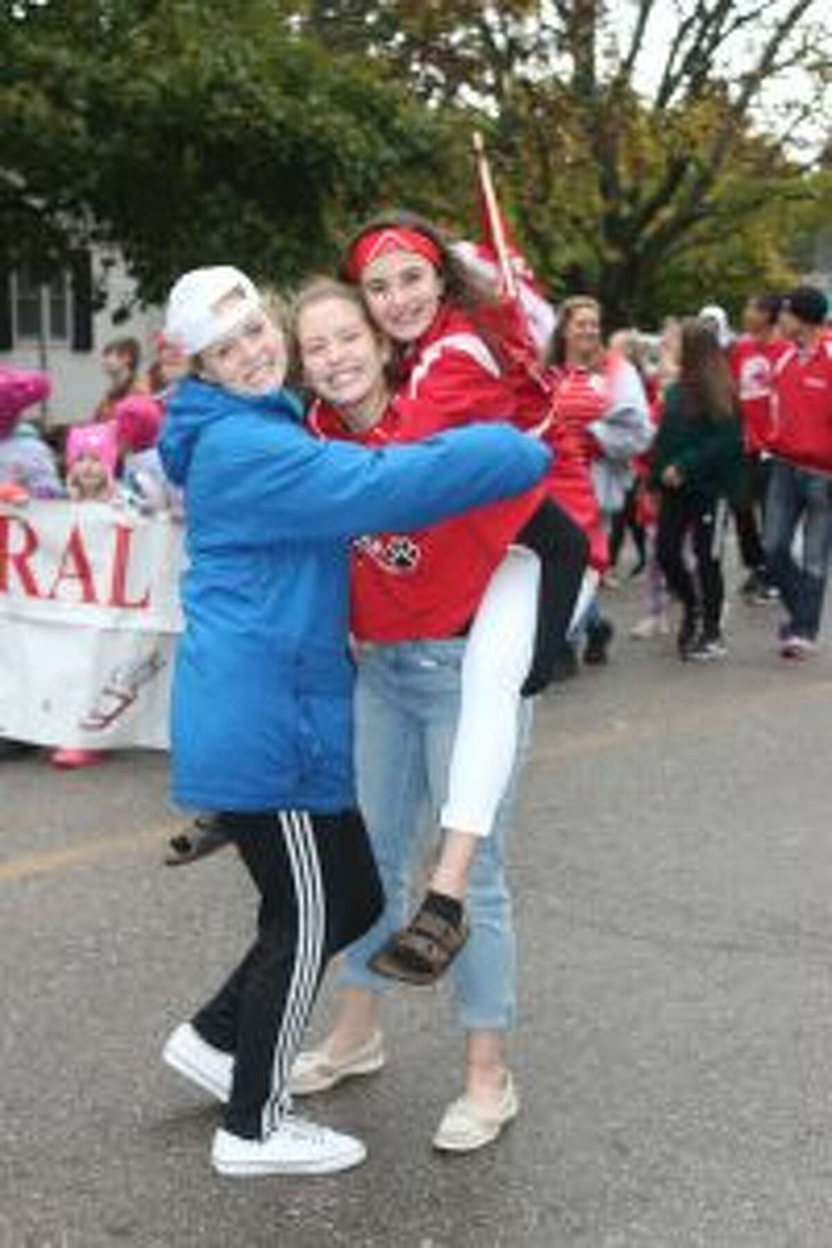 A trio of Benzie Central volleyball players enjoy marching in Friday’s homecoming parade.