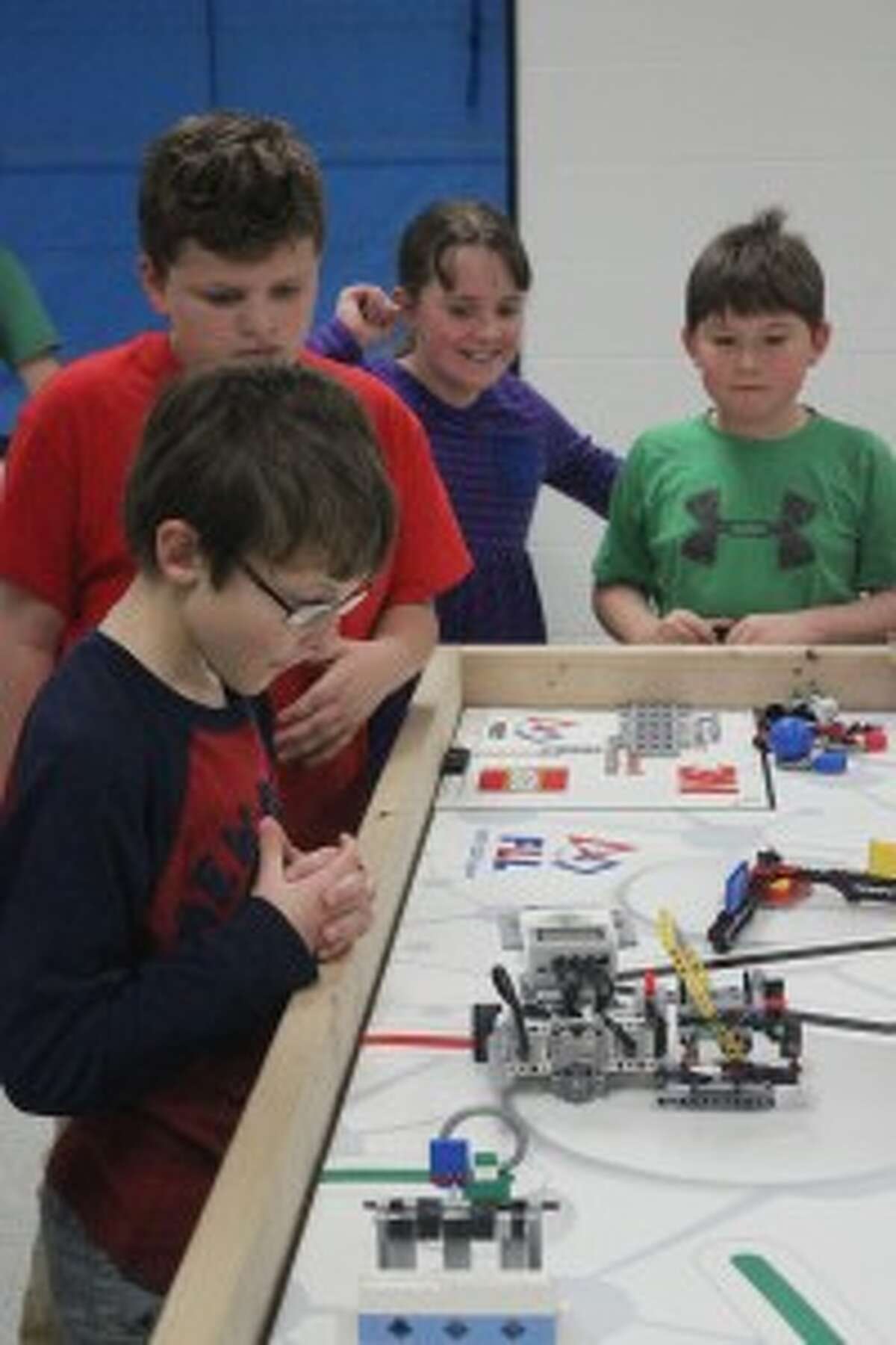 HARD WORK PAY OFF: Platte River students watch their hard work pay off as the Lego machine they built and programmed preforms for family and friends at the Lego Team’s award celebration night. (Photo/Bryan Warrick)