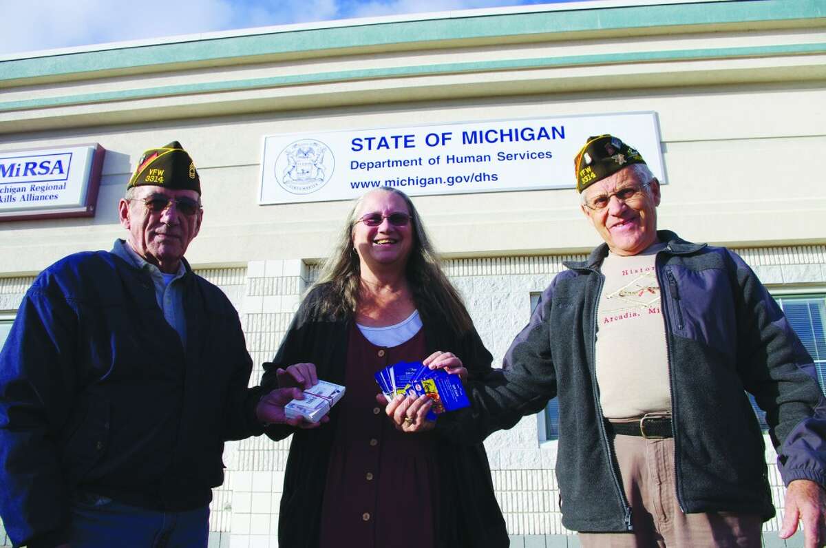 VETERANS: Officials from Arcadia VFW Post 3314 – Norman McCarry (left), commander, and Keith McArthur, quartermaster – recently presented $2,500 in grocery store gift certificates to Cosette Schaefer, community resource coordinator for the Department of Human Services for Benzie and Manistee counties. The certificates will be distributed by the Department of Human Services to veterans and their families in the two counties. (Photo/Dave Yarnell)