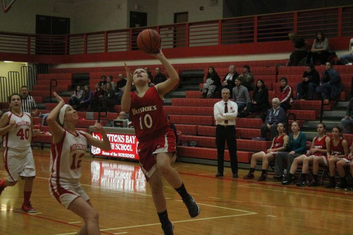 GOING UP: Benzie Central sophomore Kaitlynn Pataky lays the ball up during the game against Suttons Bay. Pataky lead the Huskies to a win in the game with nine points. (Photo/Bryan Warrick)