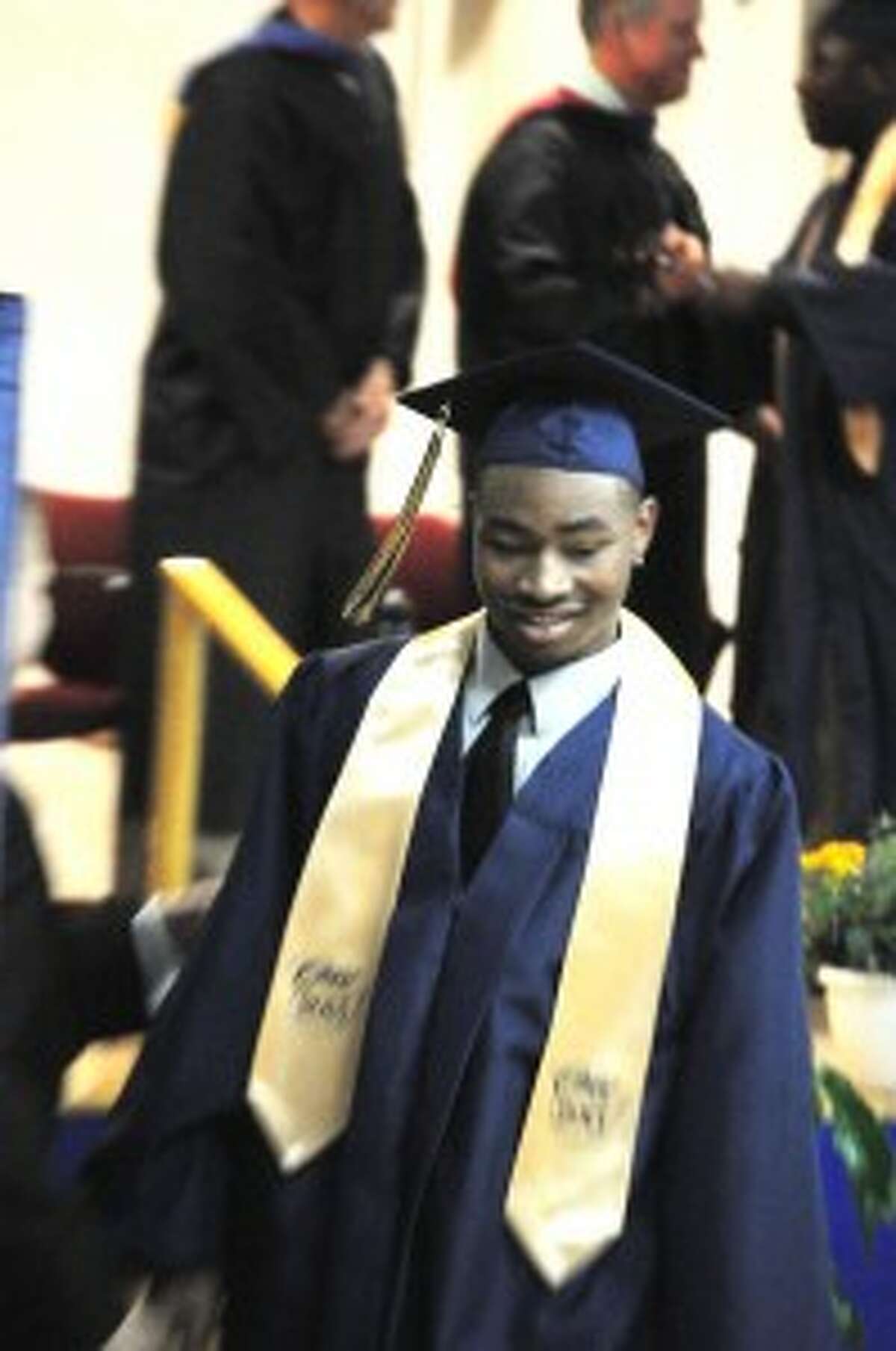 FINALLY MADE IT: (RIGHT) Anthony Horton smiles as we walks off stage after receiving his diploma. Horton was one of 14 Baldwin High School seniors who graduated on Friday.