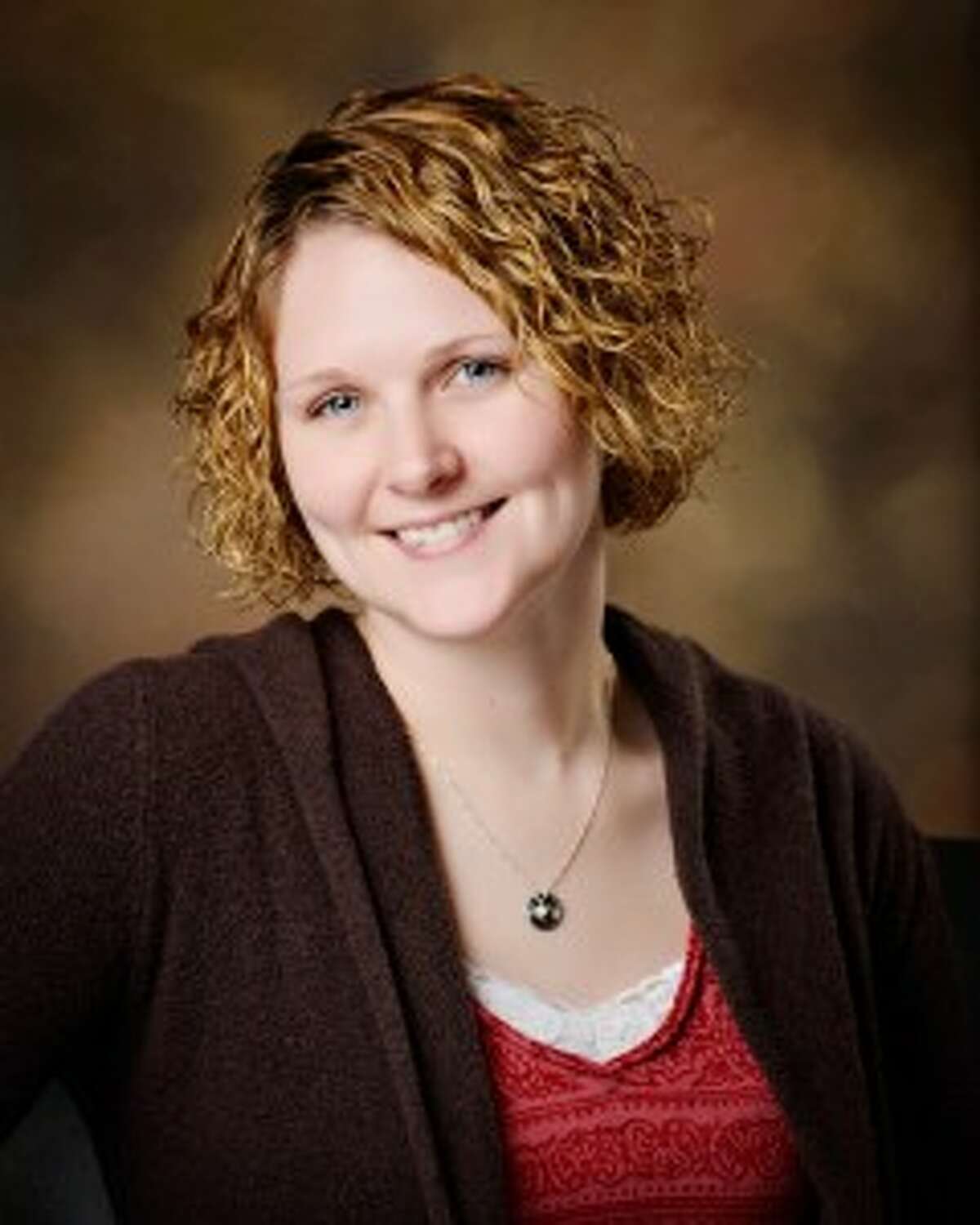 CHEESE: Miranda Green, 29, of Chase, recently earned the Certified Professional Photographer (CPP) designation from the Professional Photographic Certification Commission. She is one of less than 2,000 CPPs, 52 of which are in Michigan. (Courtesy photo)