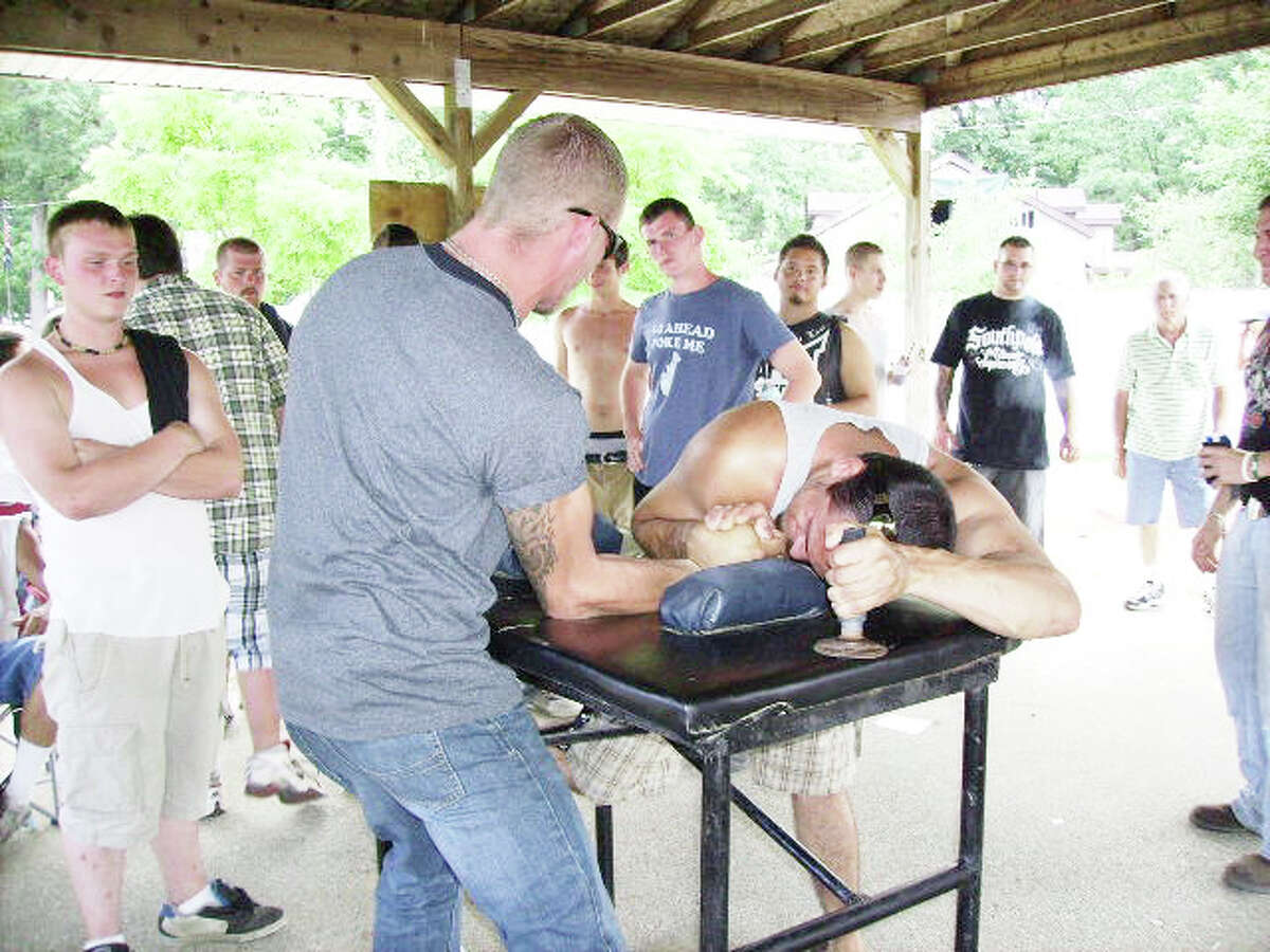 Friendly competition: Two men duke it out in an arm wrestling contest at the Bitely Homecoming Celebration 2011. (File photo)