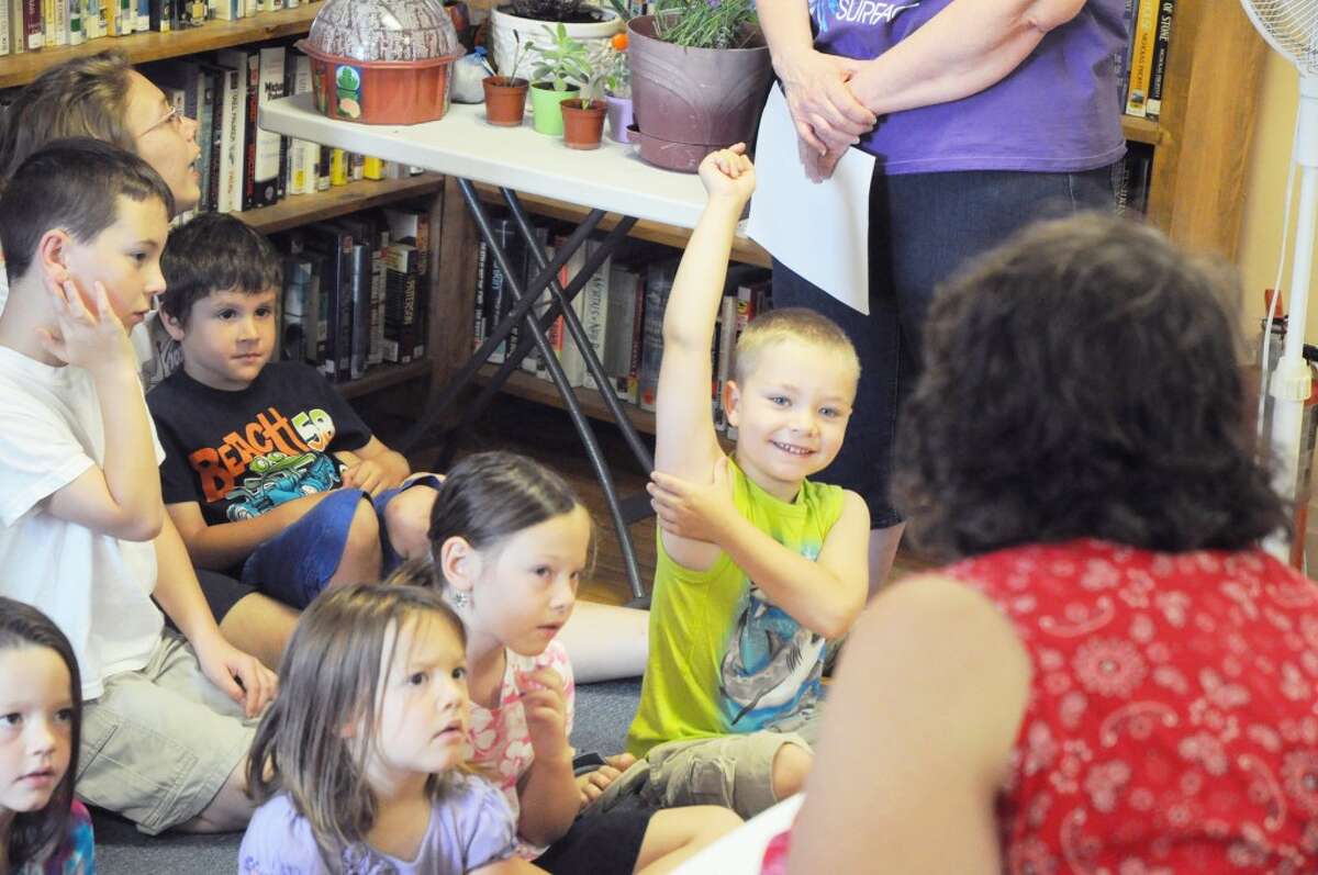Library activities: Children enjoy one of many activities during Chase Library’s summer reading program. (File Photo)