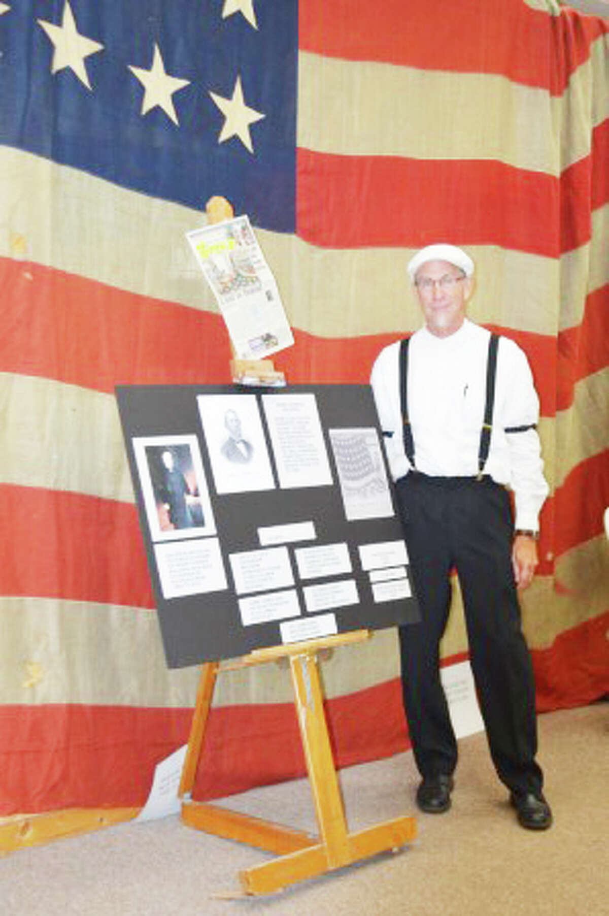 DRESSED THE PART: Lake County Historical Society President Bruce Micinski, dressed in vintage clothing, stands in front of an American flag from the 1870s during the annual Lake County History Day. (Courtesy photos)