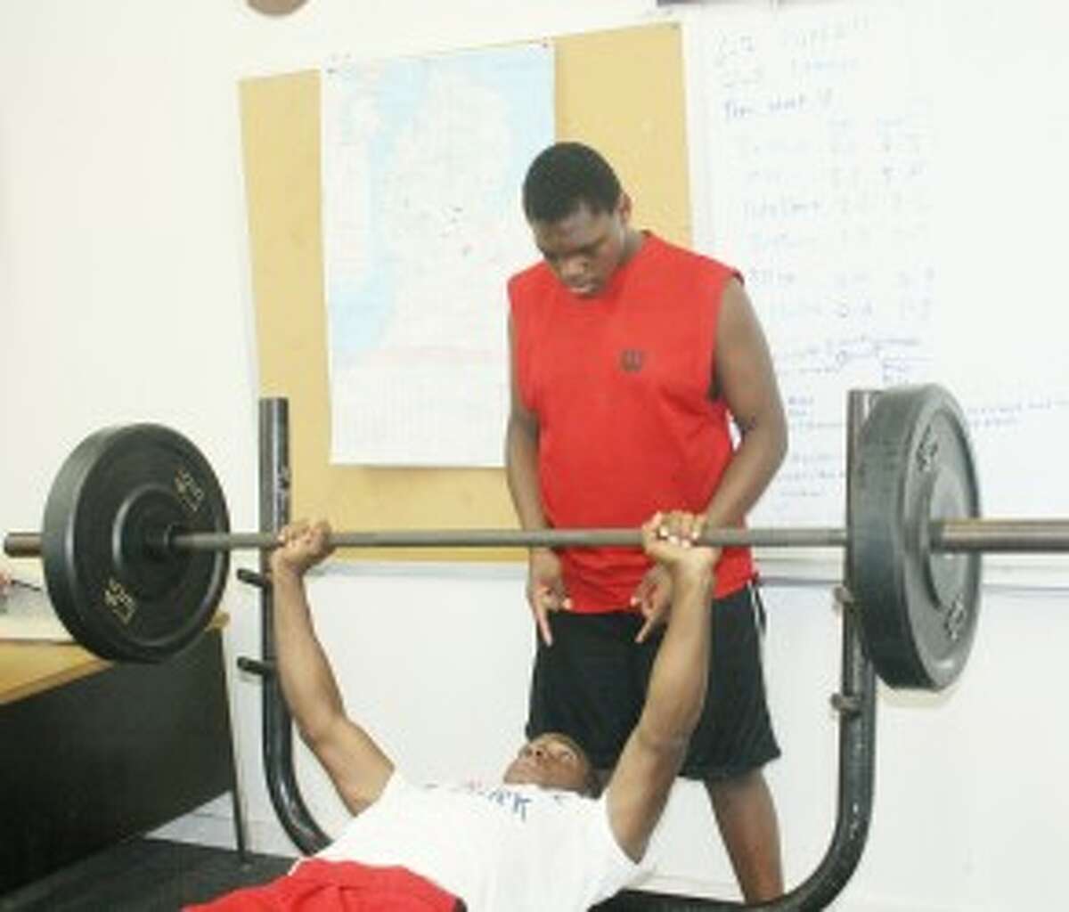 AT WORK: Dashawn Moore works out in the Baldwin weight room while La'Kie Donald watches. (Pioneer photo/John Raffel)